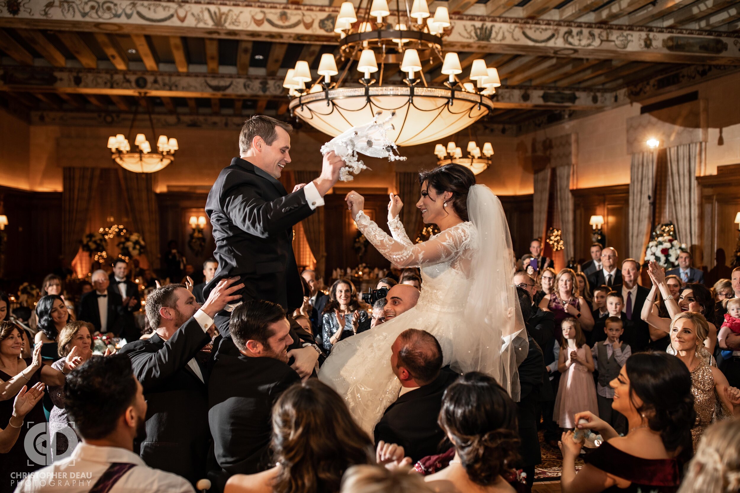  The bride and groom are lifted up during a traditional Chaldean Zaffa wedding ceremony at the Detroit Athletic Club 