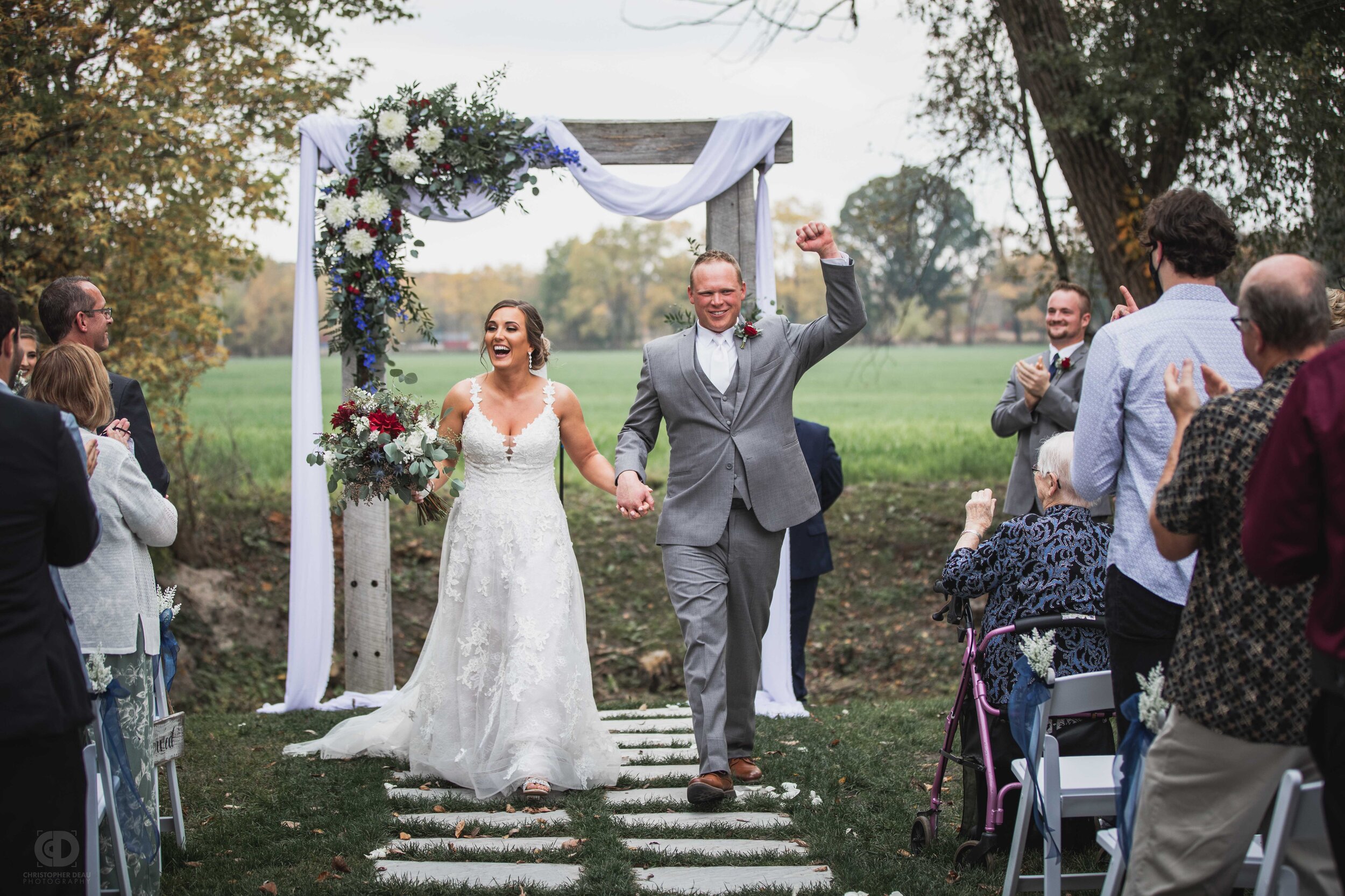  bride and groom cheer during wedding ceremony recessional  