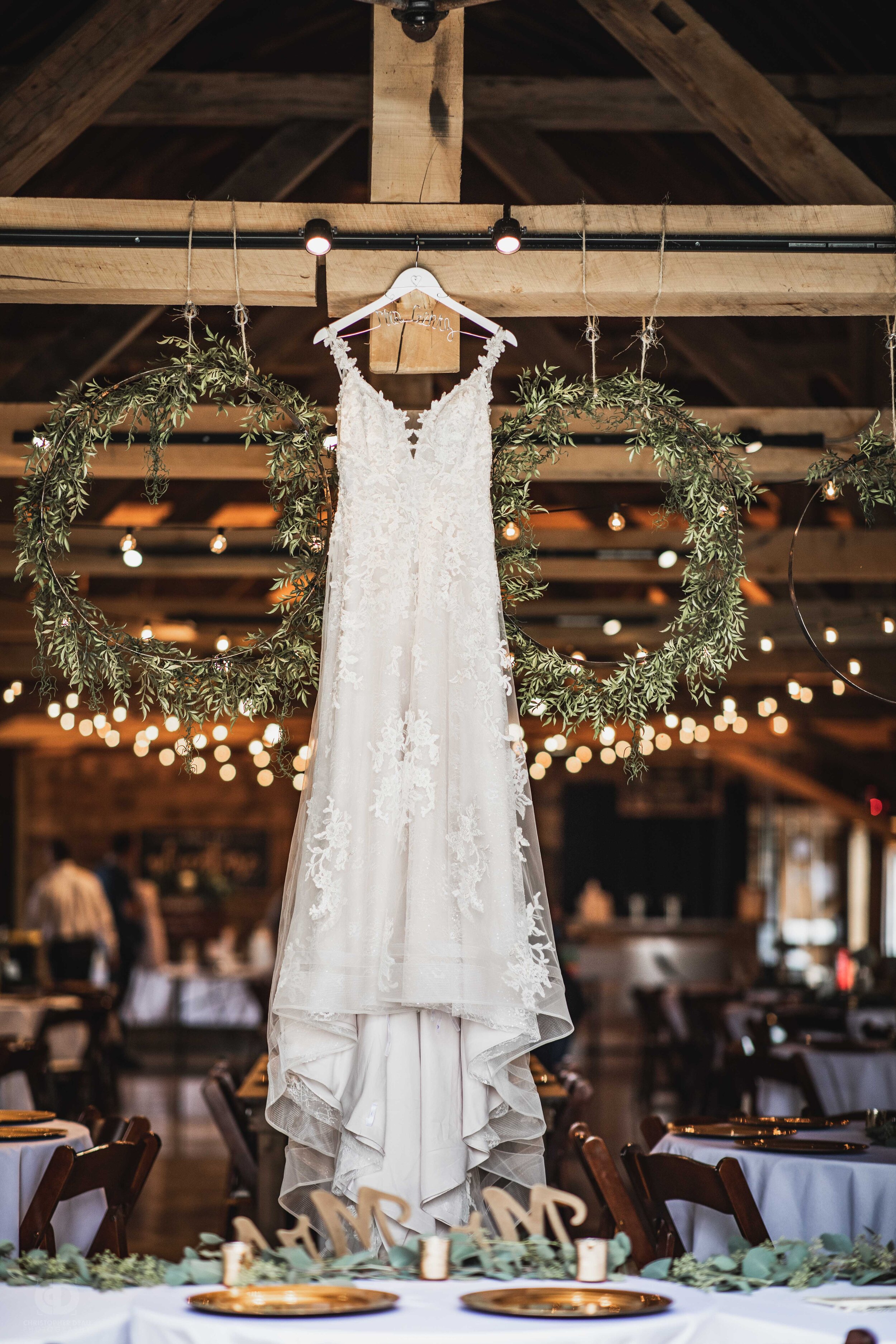  wedding dress hanging in a barn 