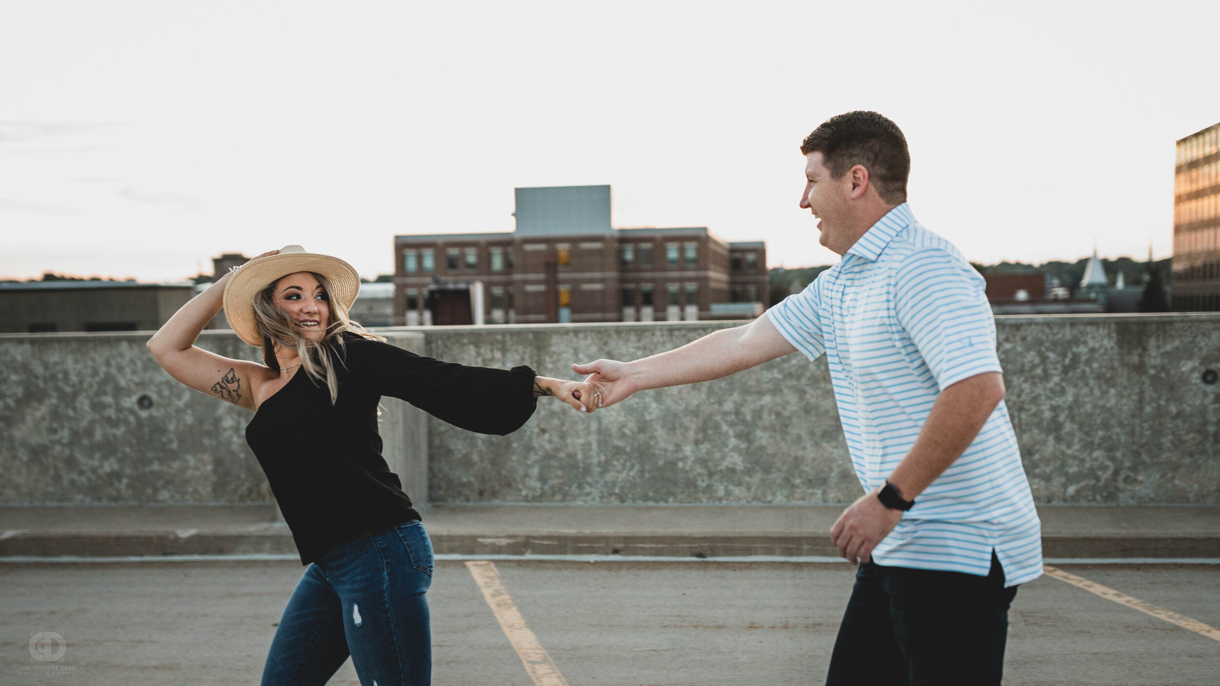 Woman running holding her hat and her partners hand.jpg