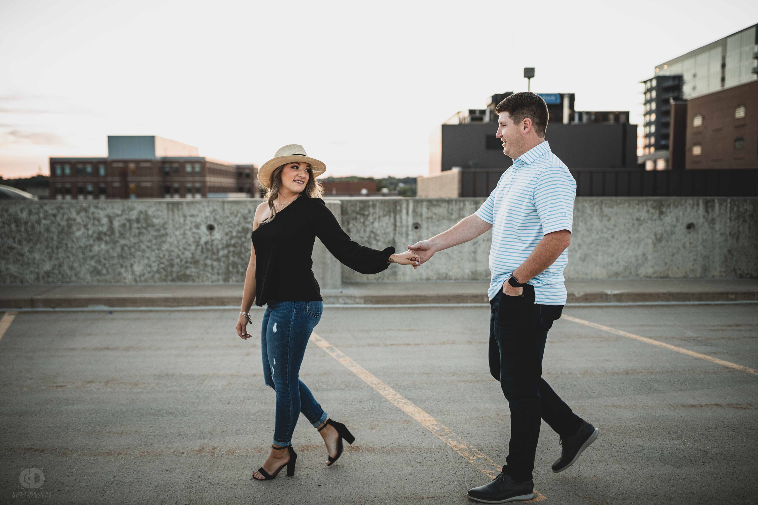 A woman leading a man on top of a parking structure overlooking Kalamazoo.jpg