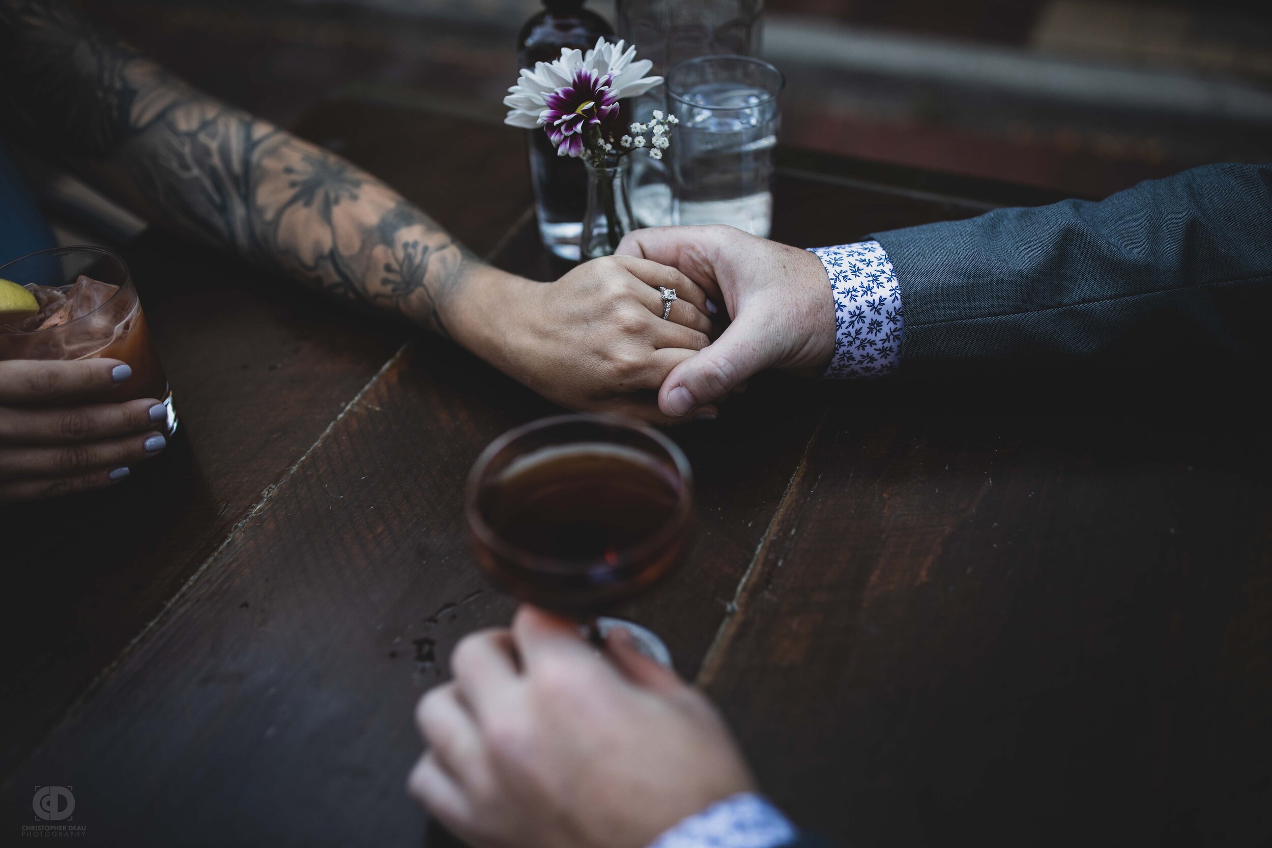 man and woman holding hands showing engagement ring.jpg