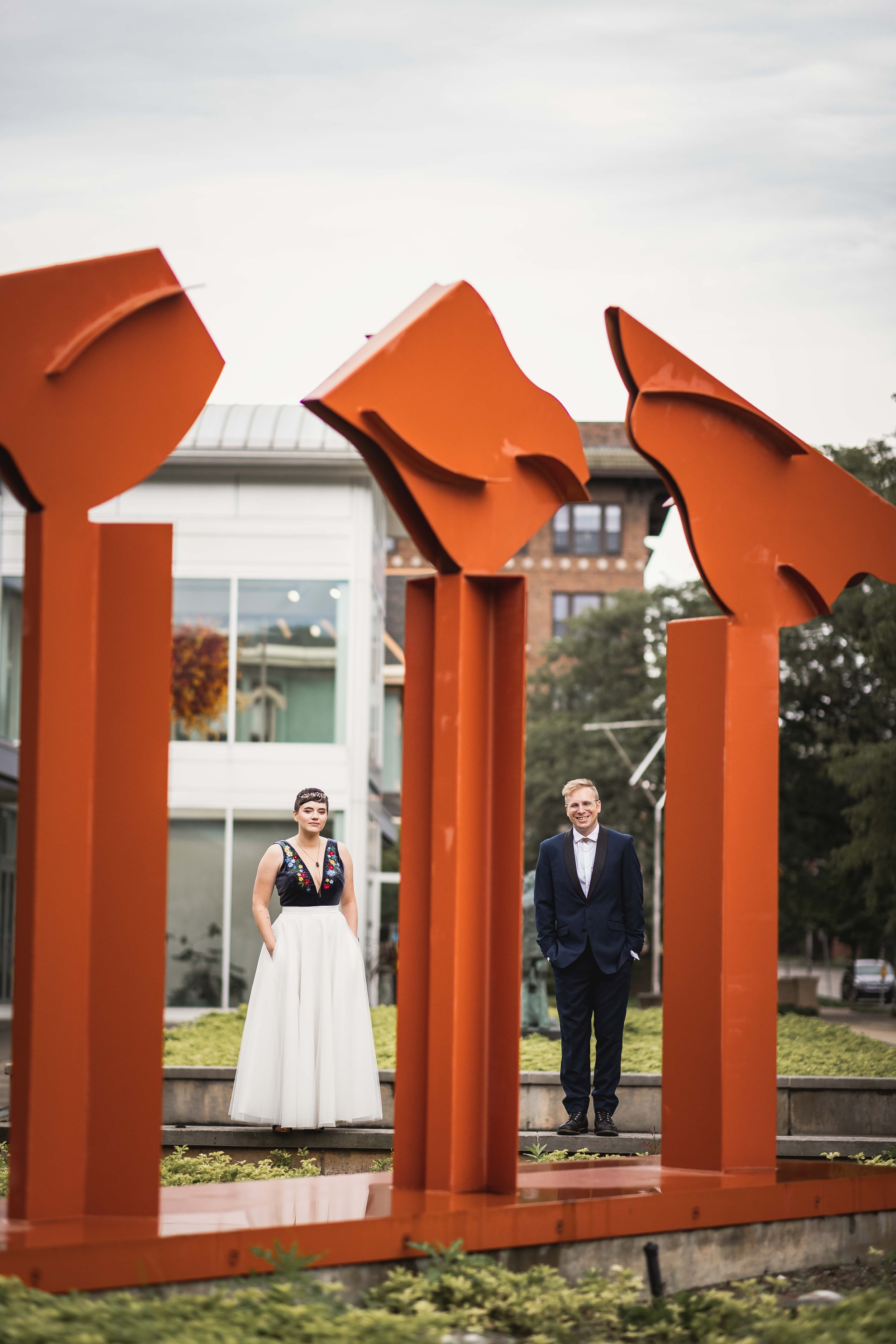  bride and groom standing between art installation at the Kalamazoo Institute of Arts 