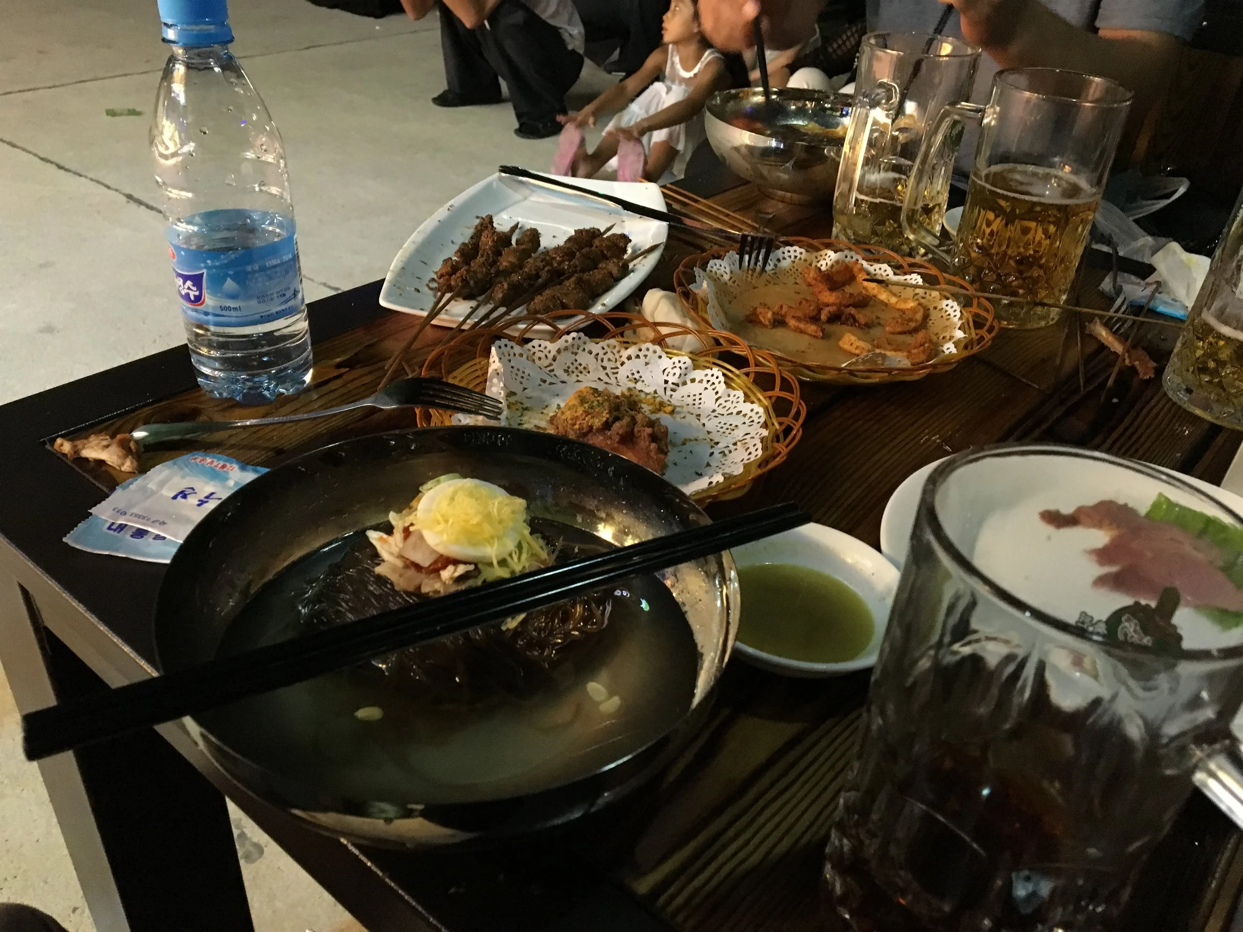  We shared a table with a North Korean family. They sand some lamb skewers, chicken wings, fries, and soba noodles. 