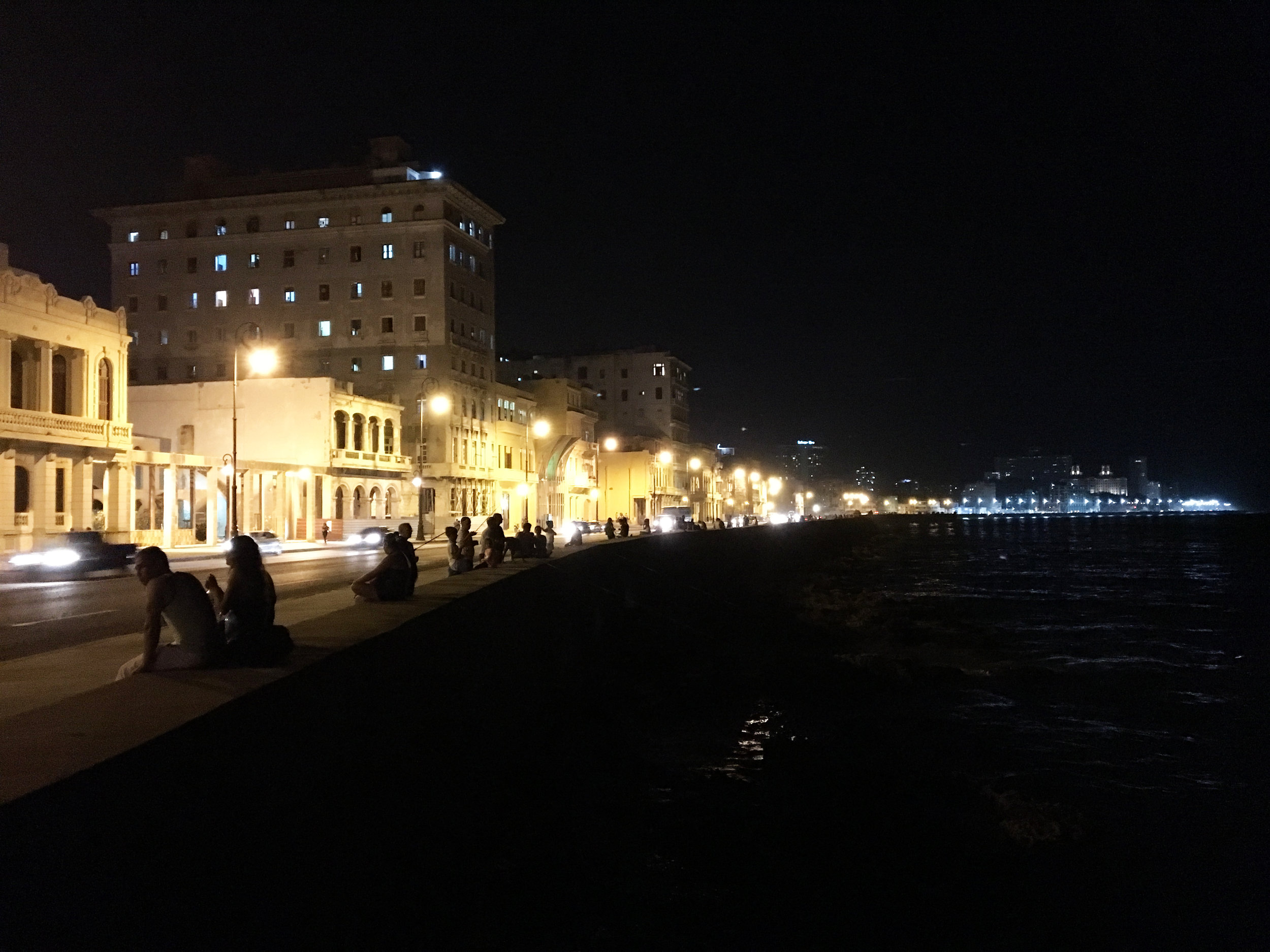 People hanging out on the Malecon in Havana at night