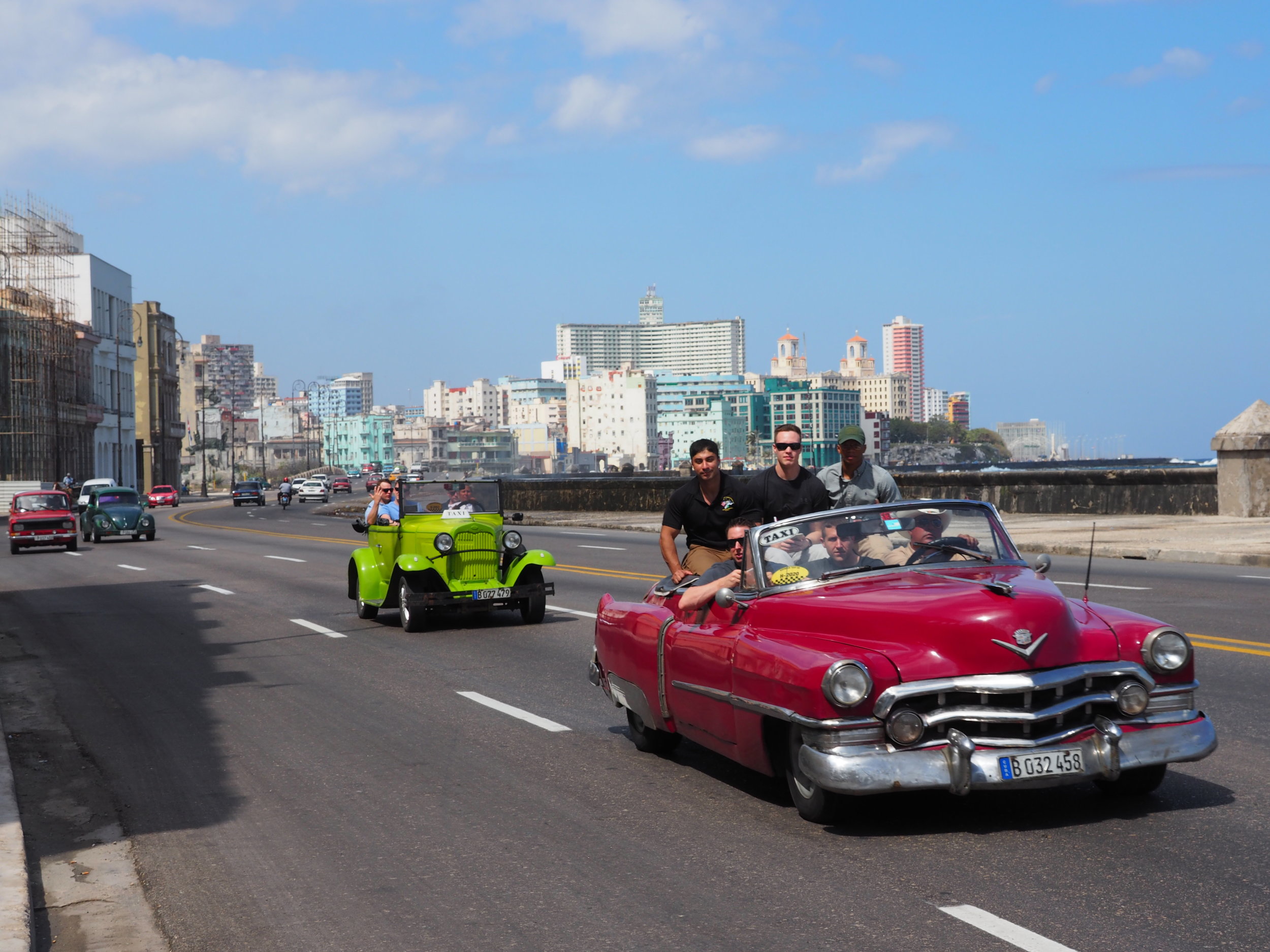 Tourists riding in a classic convertible on the Malecon