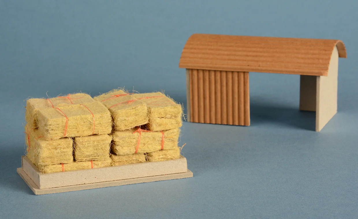 Handmade straw paper, baler twine, greyboard and corrugated card. 6cm x5cm x 14cm.
