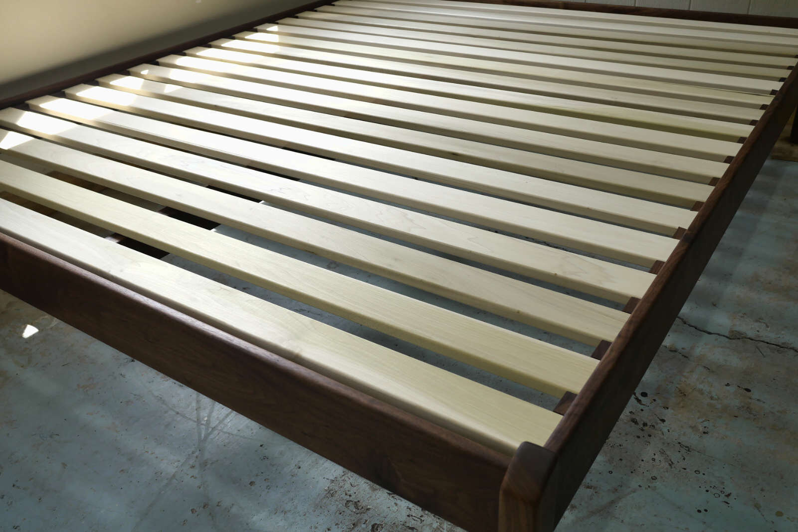 I use untreated solid hardwood (poplar) for the slats.  Each slat is 3” wide with a 1.6” gap.   This ratio works for almost any mattress and maximizes breathability while maintaining a firm, yet resilient platform.  Slats are sanded and the edges ar
