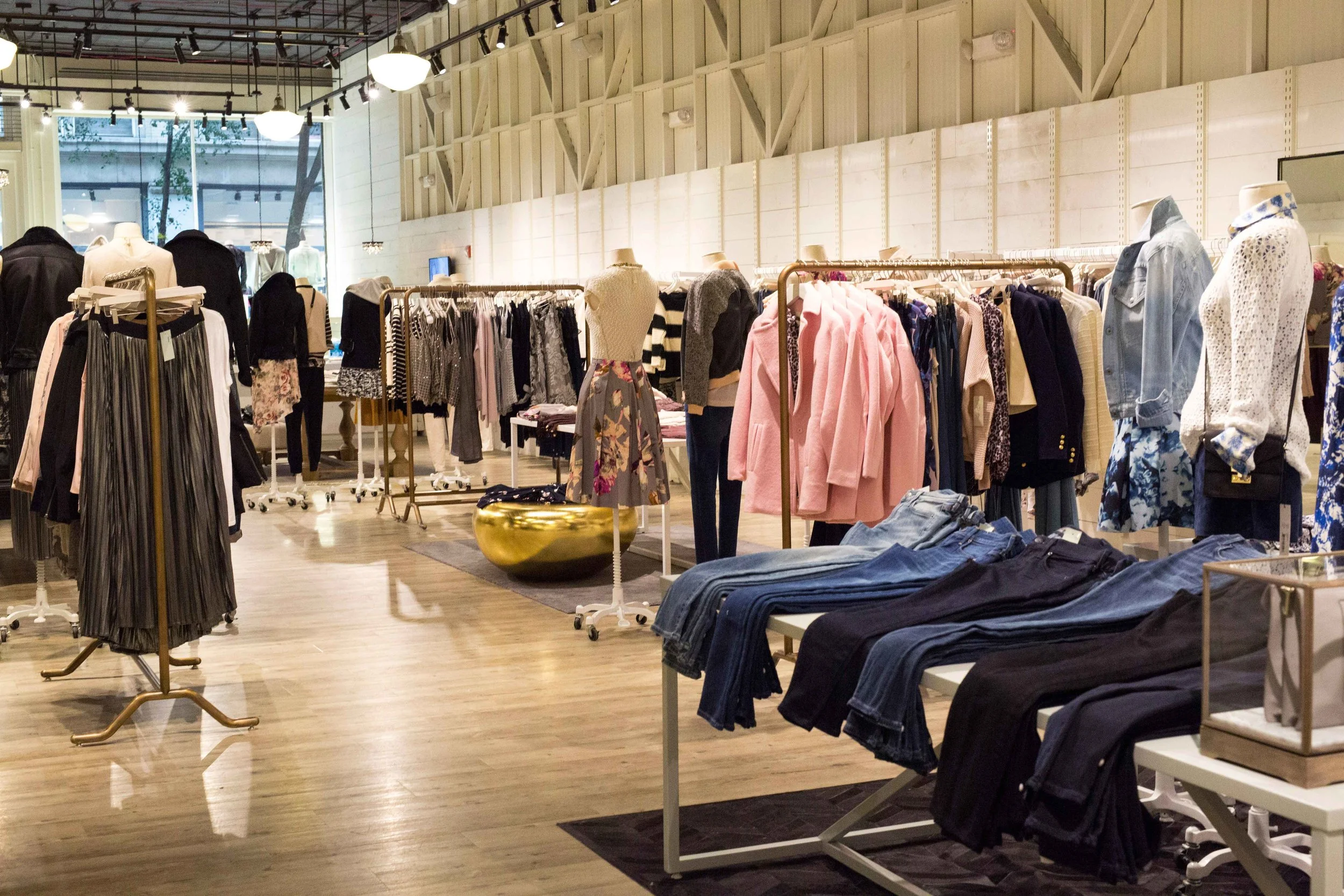 A glimpse at the floorplan. Minimal merchandising keeps a curated feel to the assortment. Luxurious rugs and unique display tables give the store a cozy feeling.