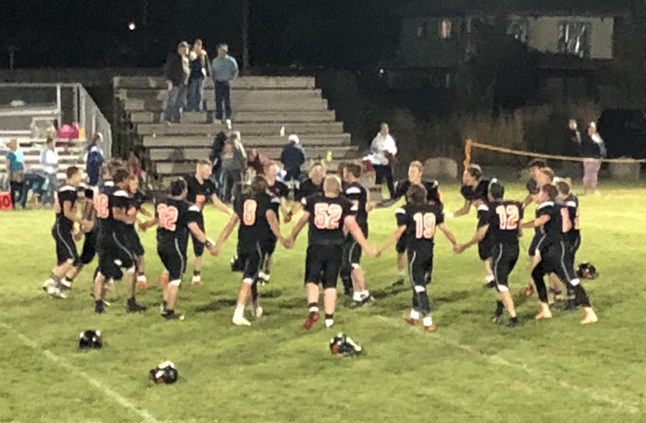 Wallowa High School football team, Huskers prayer after game tradition.