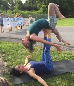 Kelly Morris and Gina Newlin Bend over Backwards and Hang in the Balance at a protest to block gas storage under Seneca Lake, a drinking source for 100,000 people.