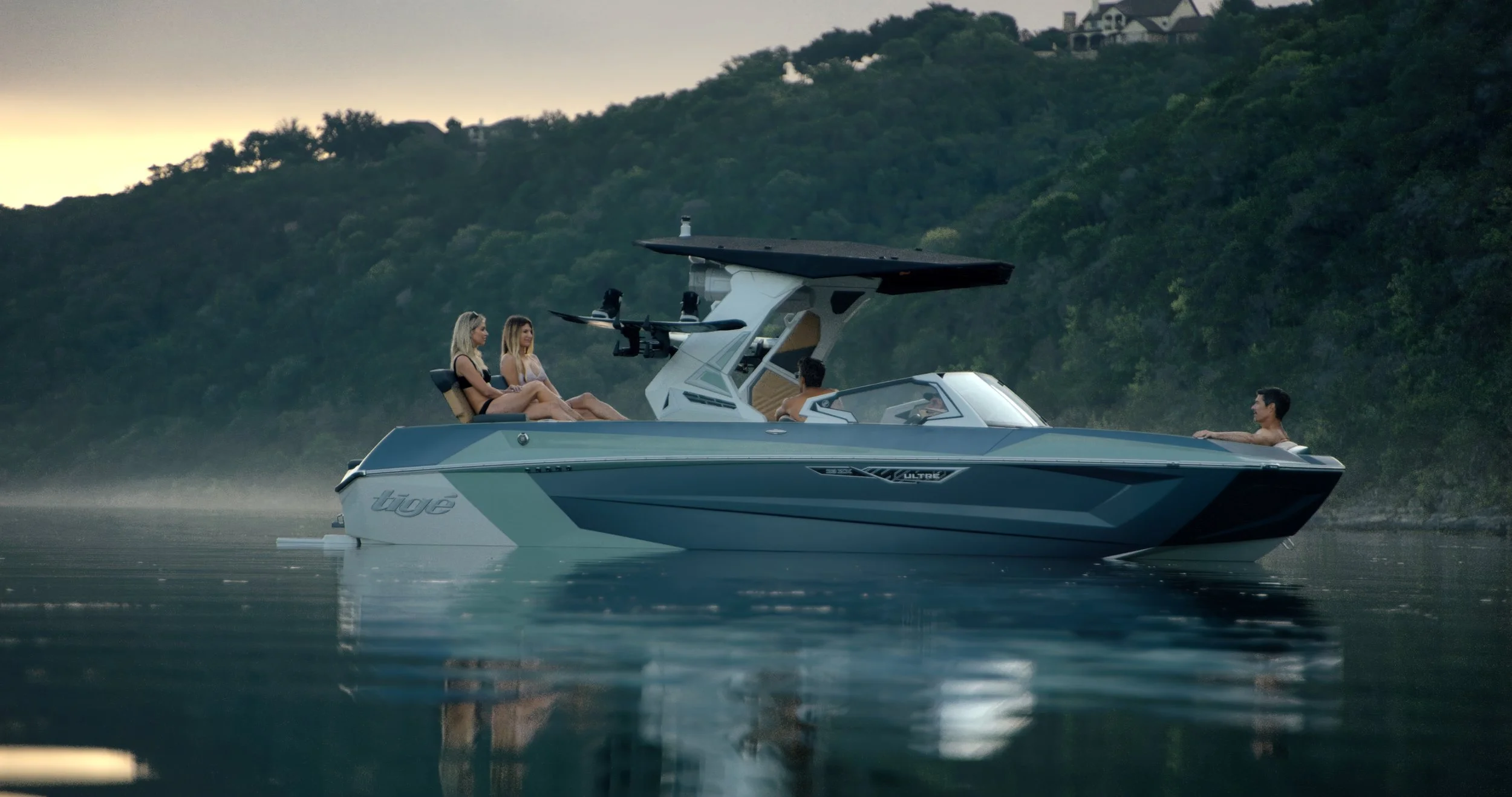 A brand new Tige Ultre ZX sits idol on the calm glassy waters of Lake Austin with boat full of people eager to get into the lake day action