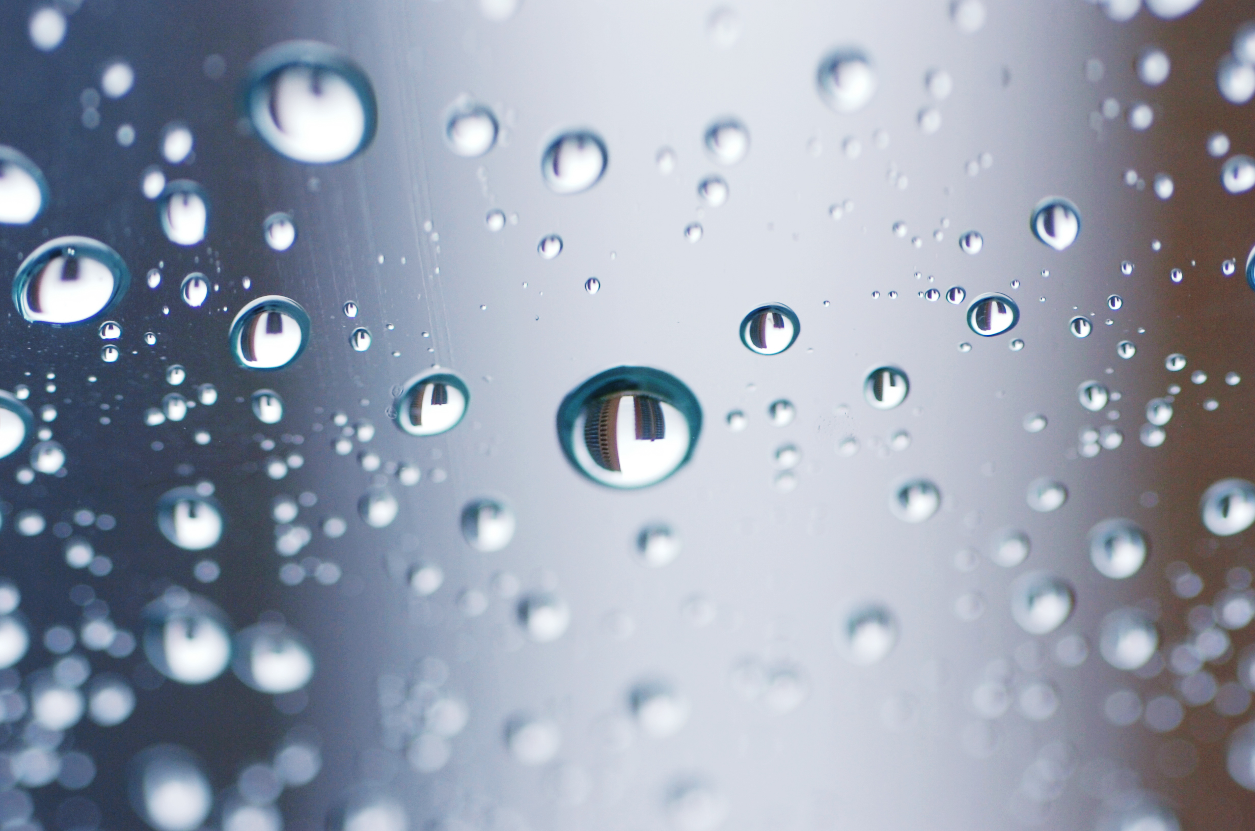 The twin high-rise dormitories at Texas Woman's University, 24-story Guinn Hall and 21-story Stark Hall, are refracted in rain drops on the windshield of a vehicle as rain and colder temperatures cover north texas, Tuesday, October 15, 2013, in Dent