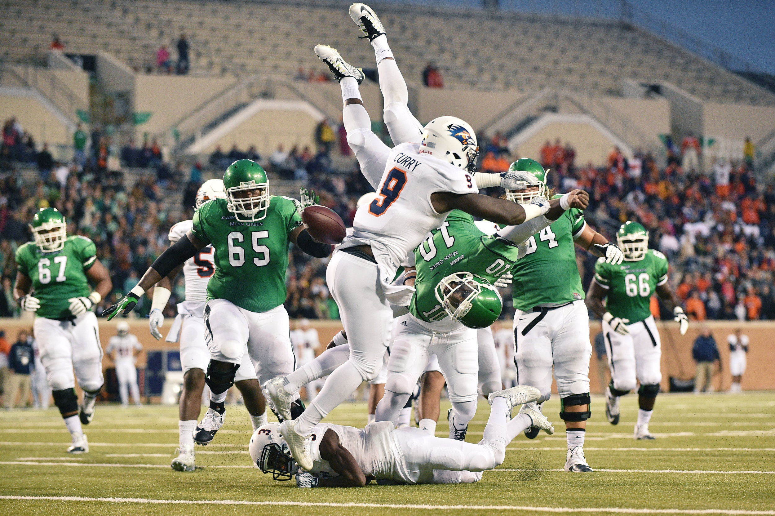 North Texas junior quarterback DaMarcus Smith (10) fumbles the ball after being knocked vertical while diving into the end zone by Texas-San Antonio freshman corner Stanley Dye Jr (3) and sophomore linebacker Macros Curry (9), Saturday, October 31,