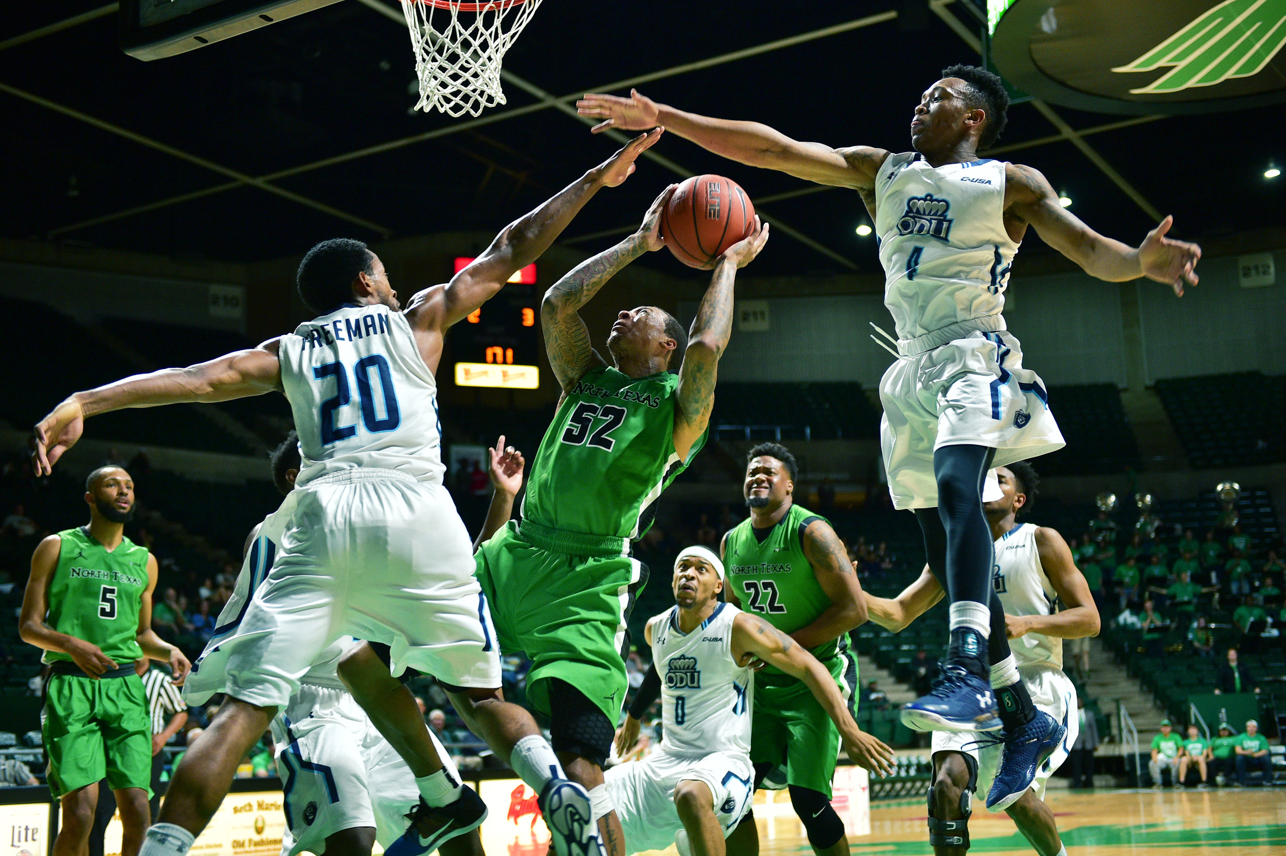 North Texas junior guard J-Mychal Reese (52) tries to shoot through coverage by Old Dominion senior guard Trey Freeman (20) and freshman guard Ahmad Caver (4), Thursday, March 3, 2016, at the Super Pit in Denton, Texas. 