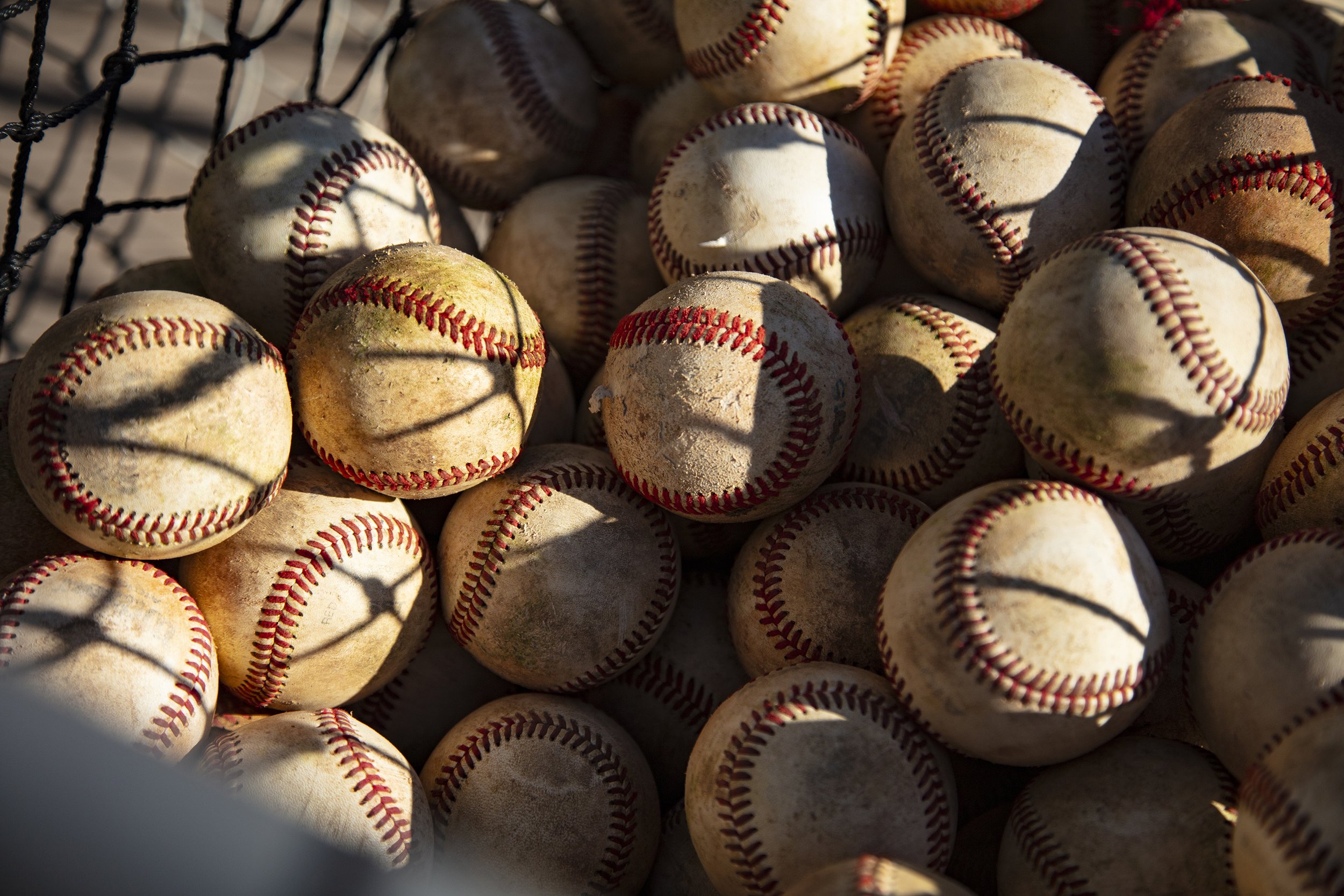  Stacks of well-worn baseballs sit in a basket ready for practice, Thursday, April 4, 2024, in Ahwatukee, Arizona. (David Minton/Ahwatukee Foothills News) 