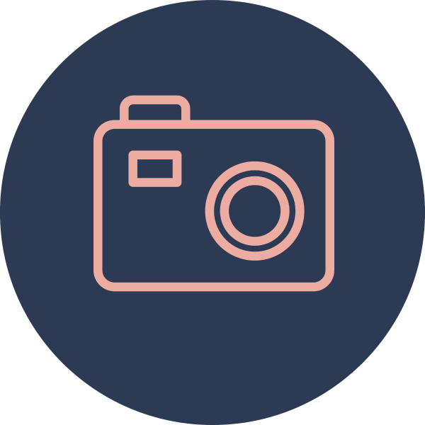 Icon of a camera with a pink outline on a dark blue circular background.