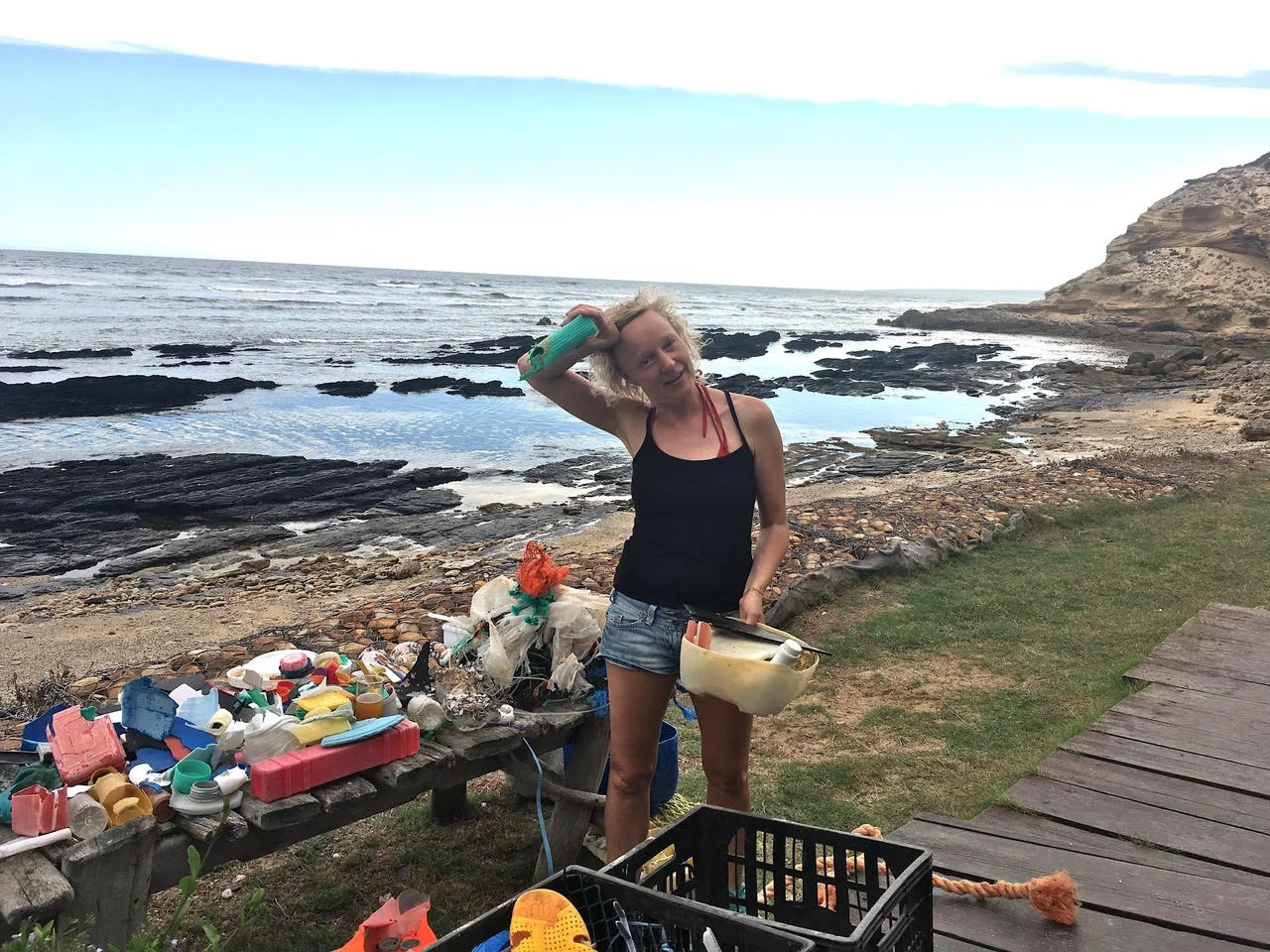 Thirza collecting plastic at the beach on er recent road trip