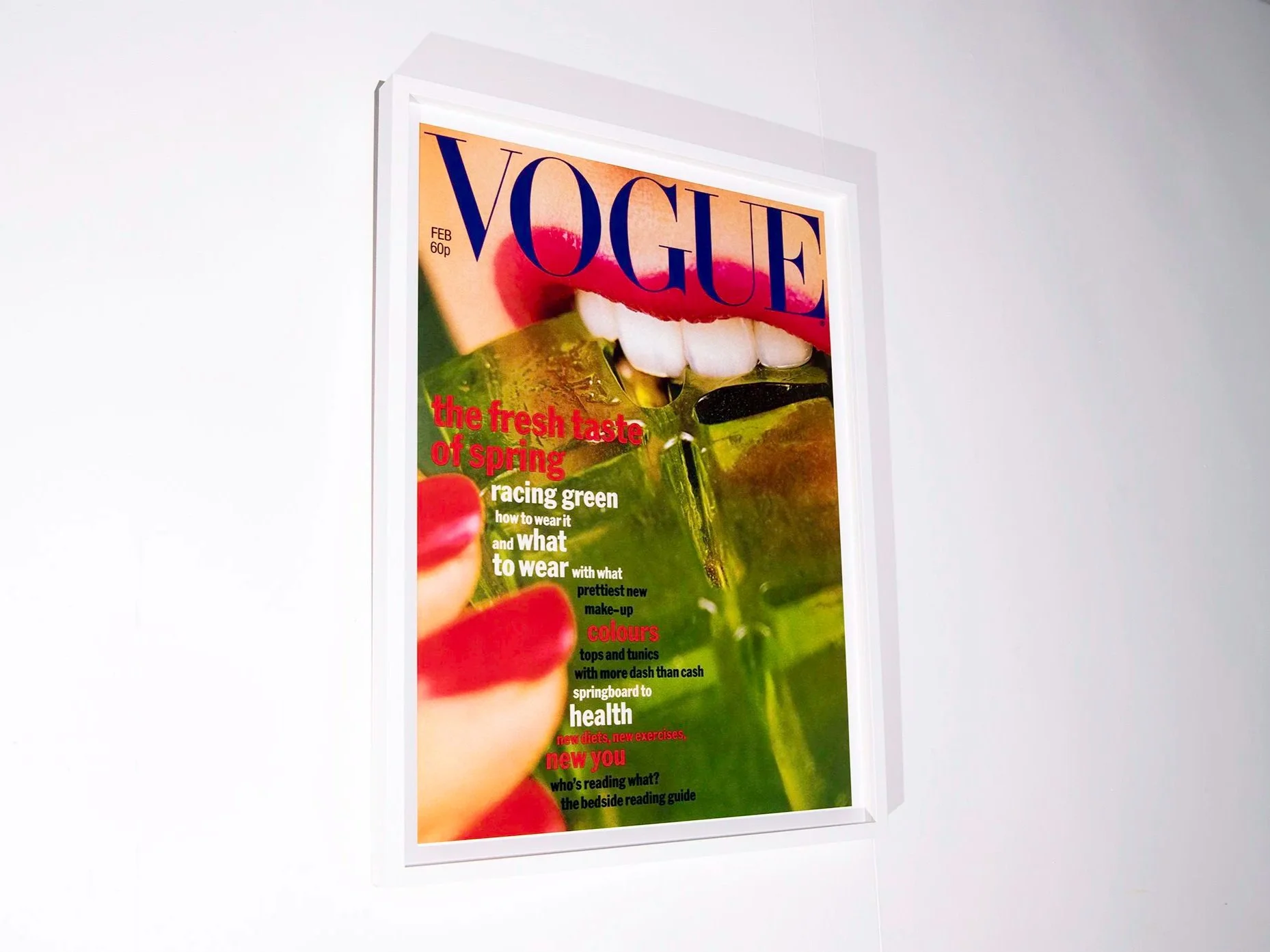 Vogue magazine cover featuring a close-up of lips and teeth with green apples, with headlines about spring fashion, makeup, and health