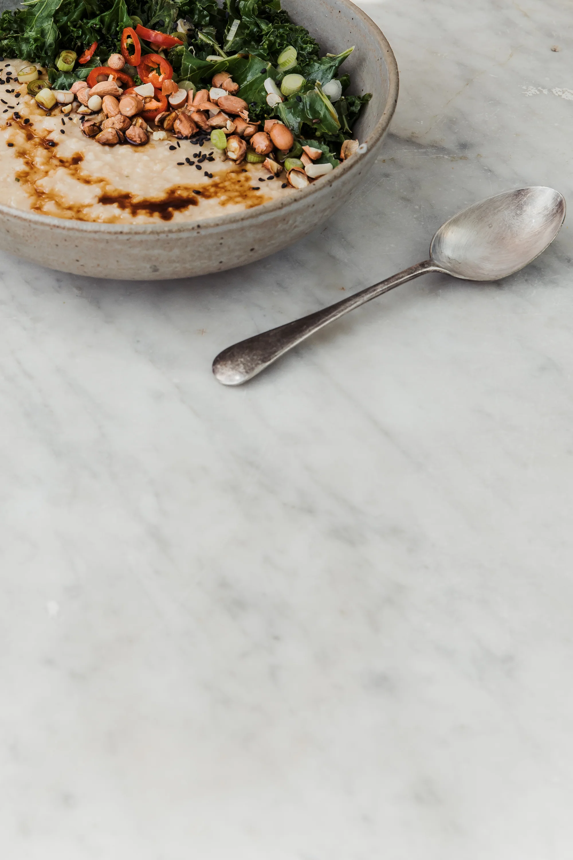 Savoury Indonesian Porridge with Garlic Sautéed Kale, Chilli, Soy Sauce, and Toasted Peanuts