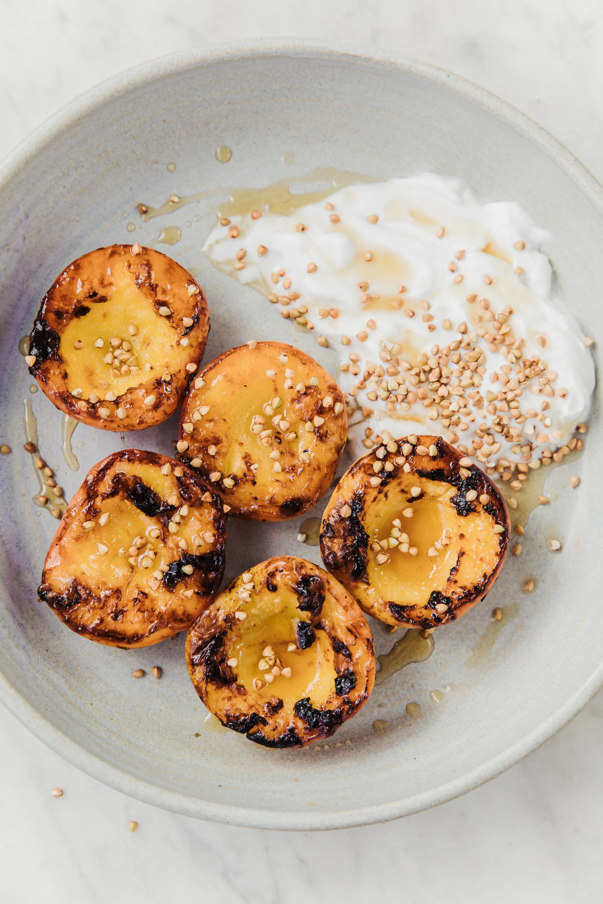 Charred Honey Peaches with Whipped Vanilla Coconut Yoghurt and Toasted Buckwheat