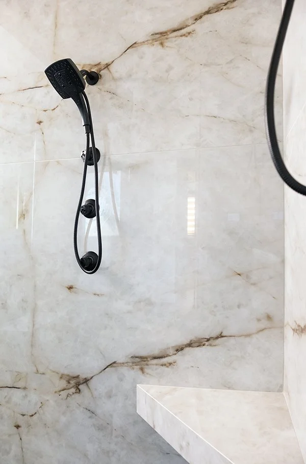 Partial view of Himalayan Crystal porcelain shower with bench.