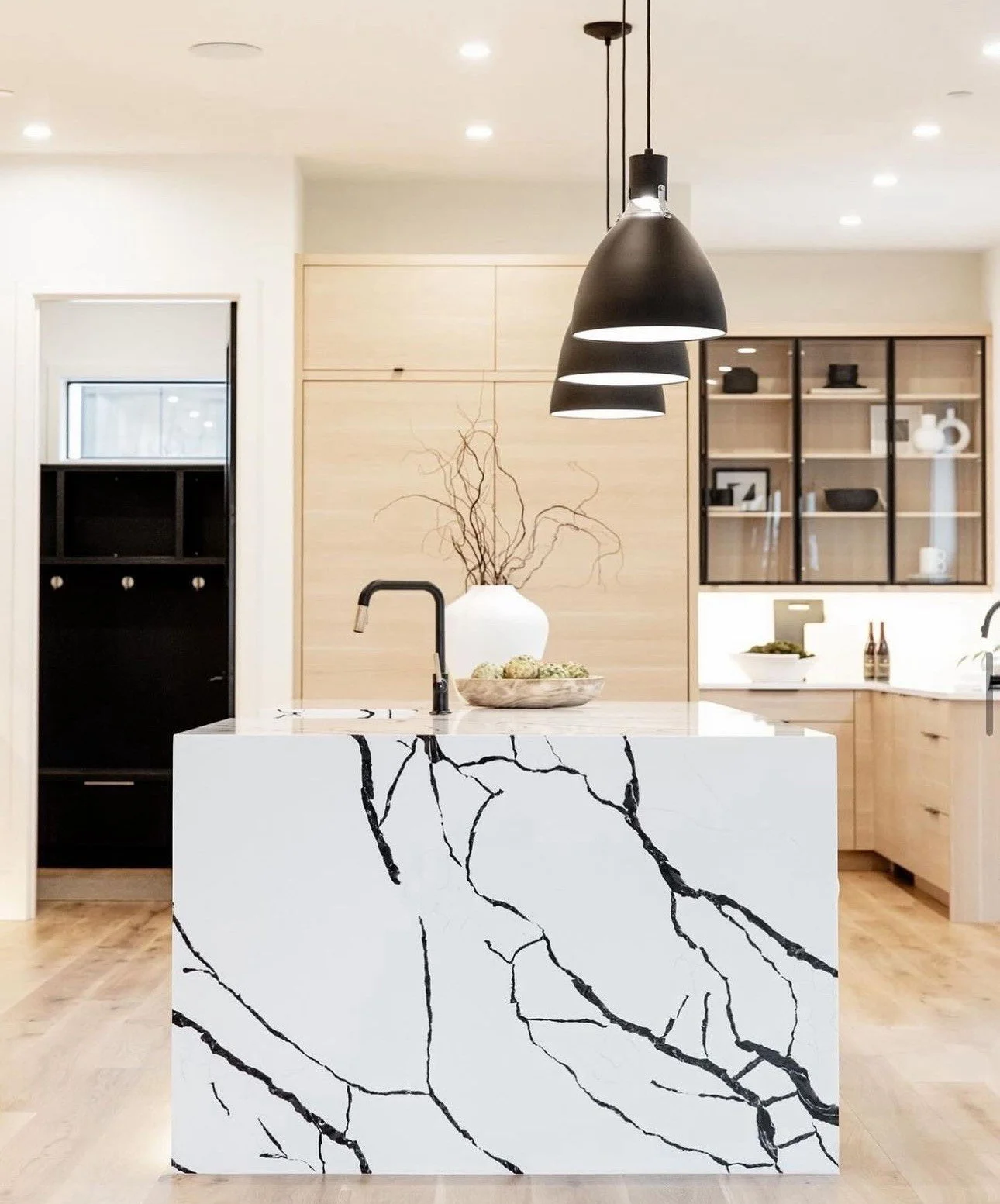 Stratus Regal Calacatta Zeal quartz island of white with black marble veins.