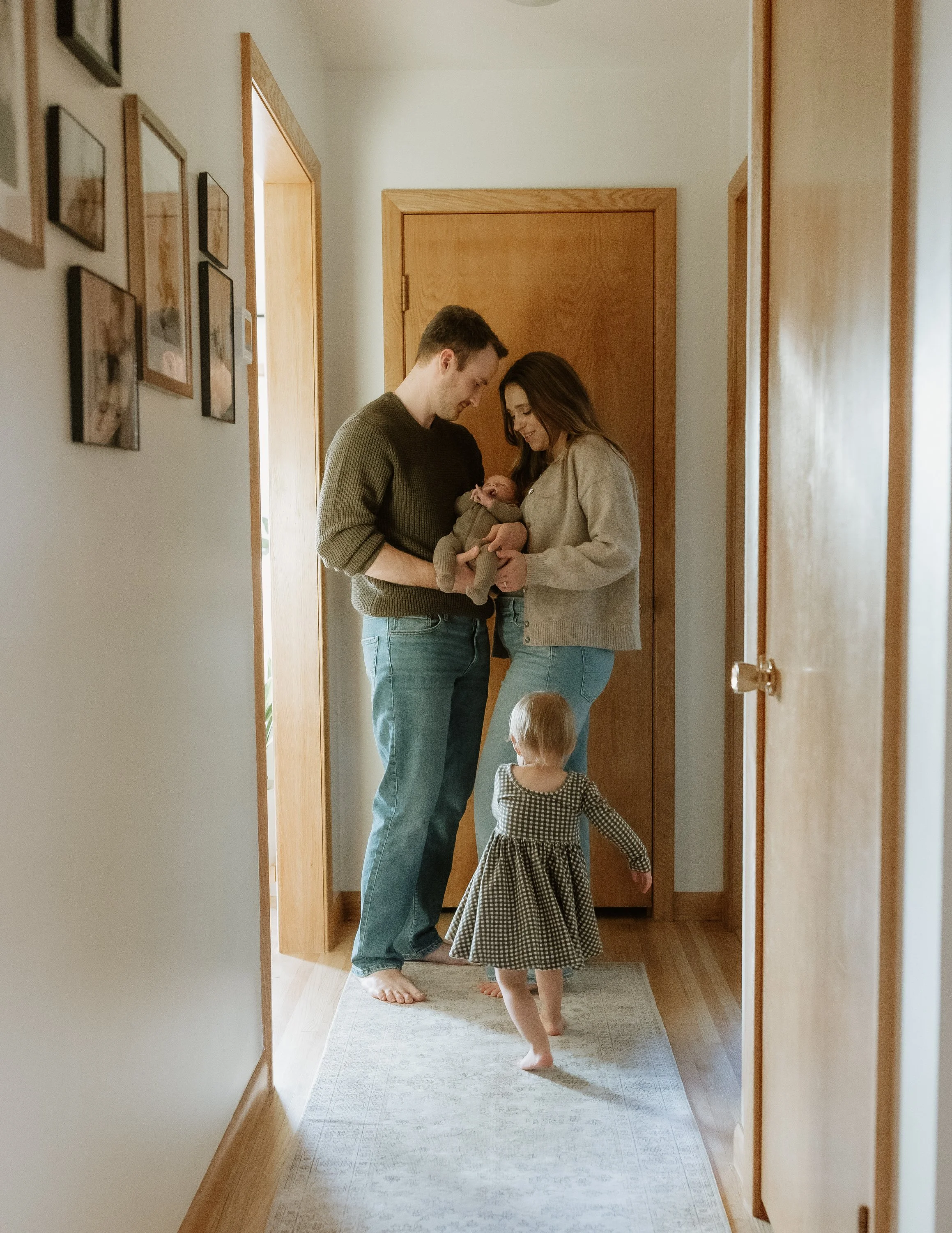 family in home session standing in hallway
