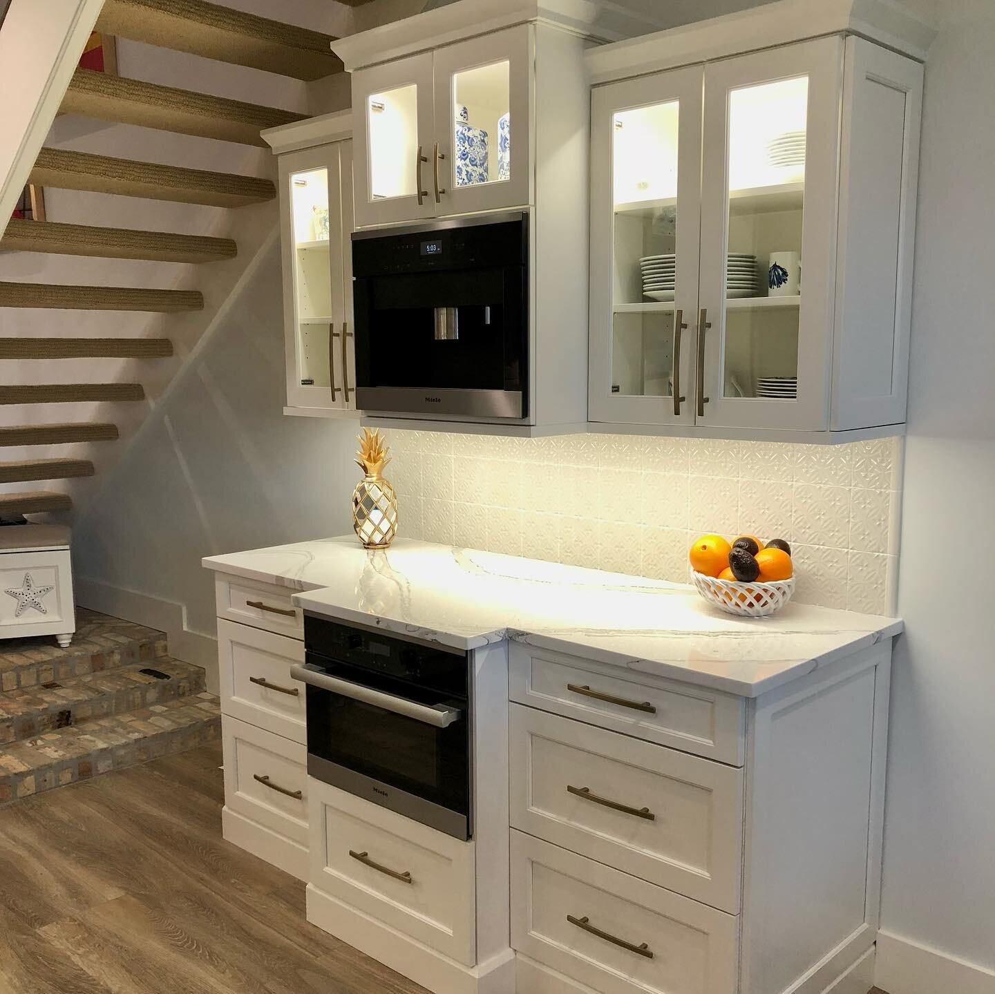 One of my favorite transformations- we called it the coastal cottage. I raised the ceilings, which meant relocating HVAC ducts and units to the attic on the third floor, imported beautiful Steamwood blonde faux wood tile from Italy along with corresp
