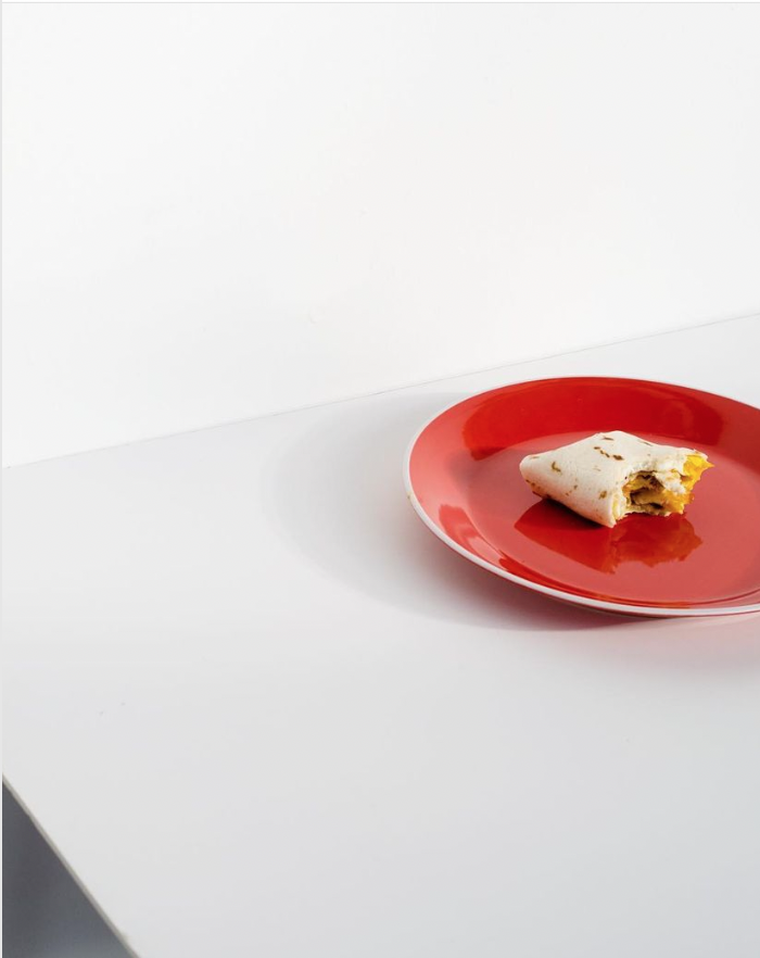 egg burrito on red plate art photography food brittany byrne.png
