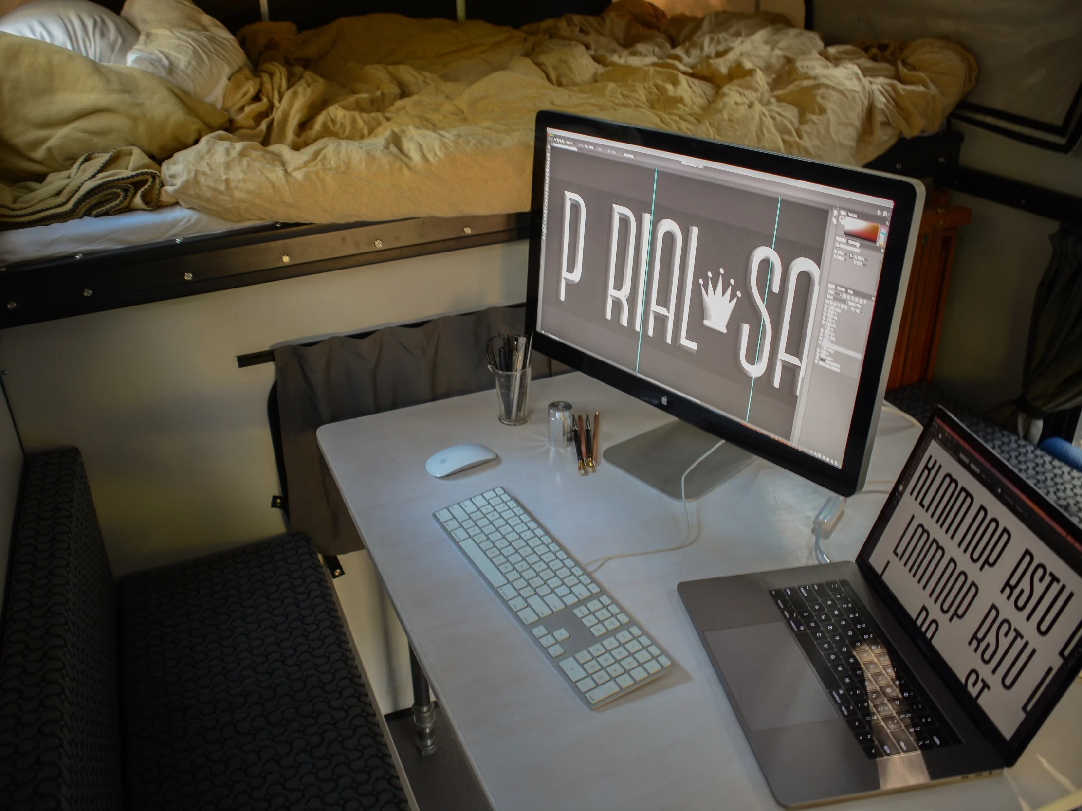 Inside the rig. I like a big desk for pencil sketching and my massive Apple Cinema Display for when it's time to go digital. The desk is homemade from 1-inch plywood and steel pipe legs.