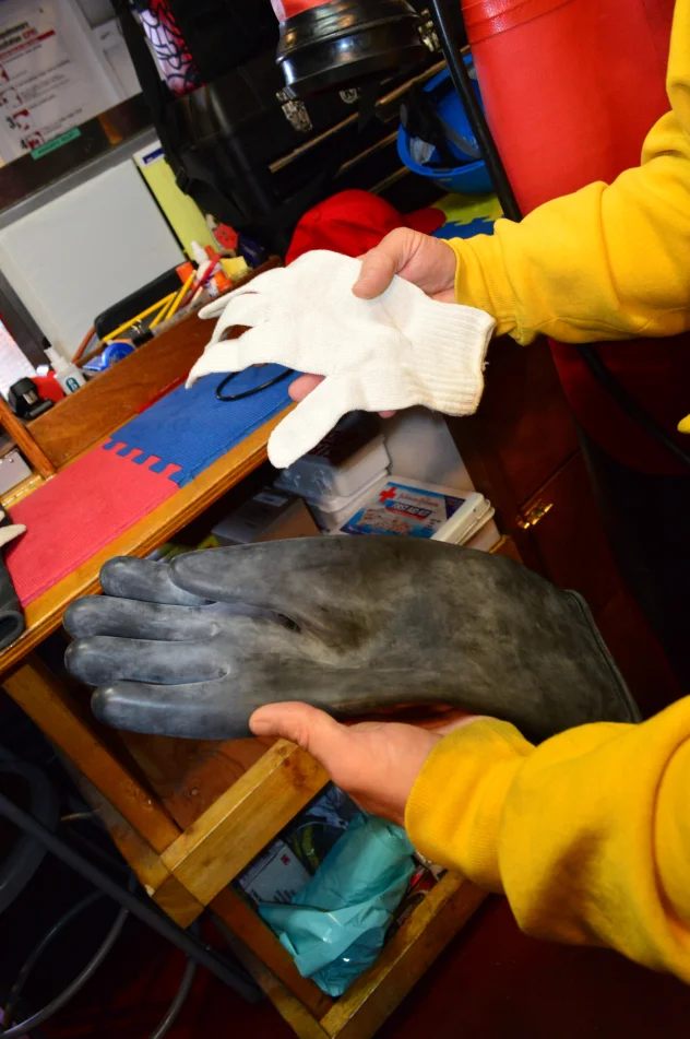 Demonstrating glove construction and layering for pressurized suits used in extreme environments, in this case deep underwater.