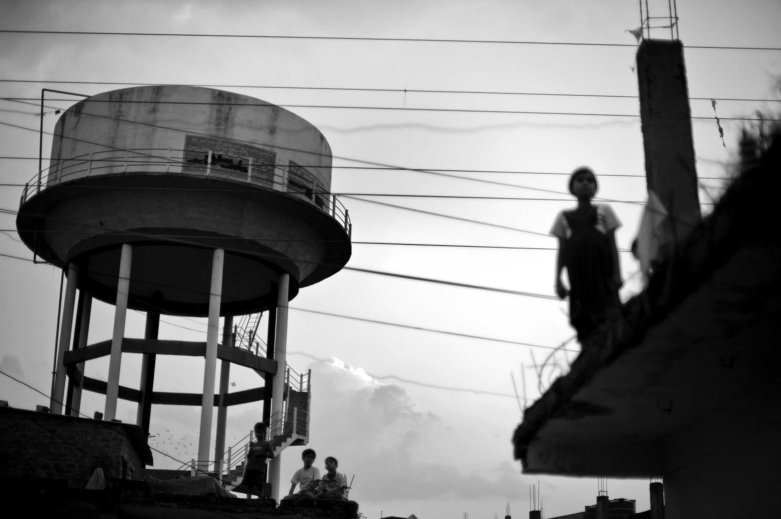 Children play on roofs near a water tower in the city of Bhopal in the state Madhya Pradesh, India.  Twenty-five years after a gas leak in the Union Carbide factory in Bhopal killed at least eight thousand people, toxic material from the ‘biggest in