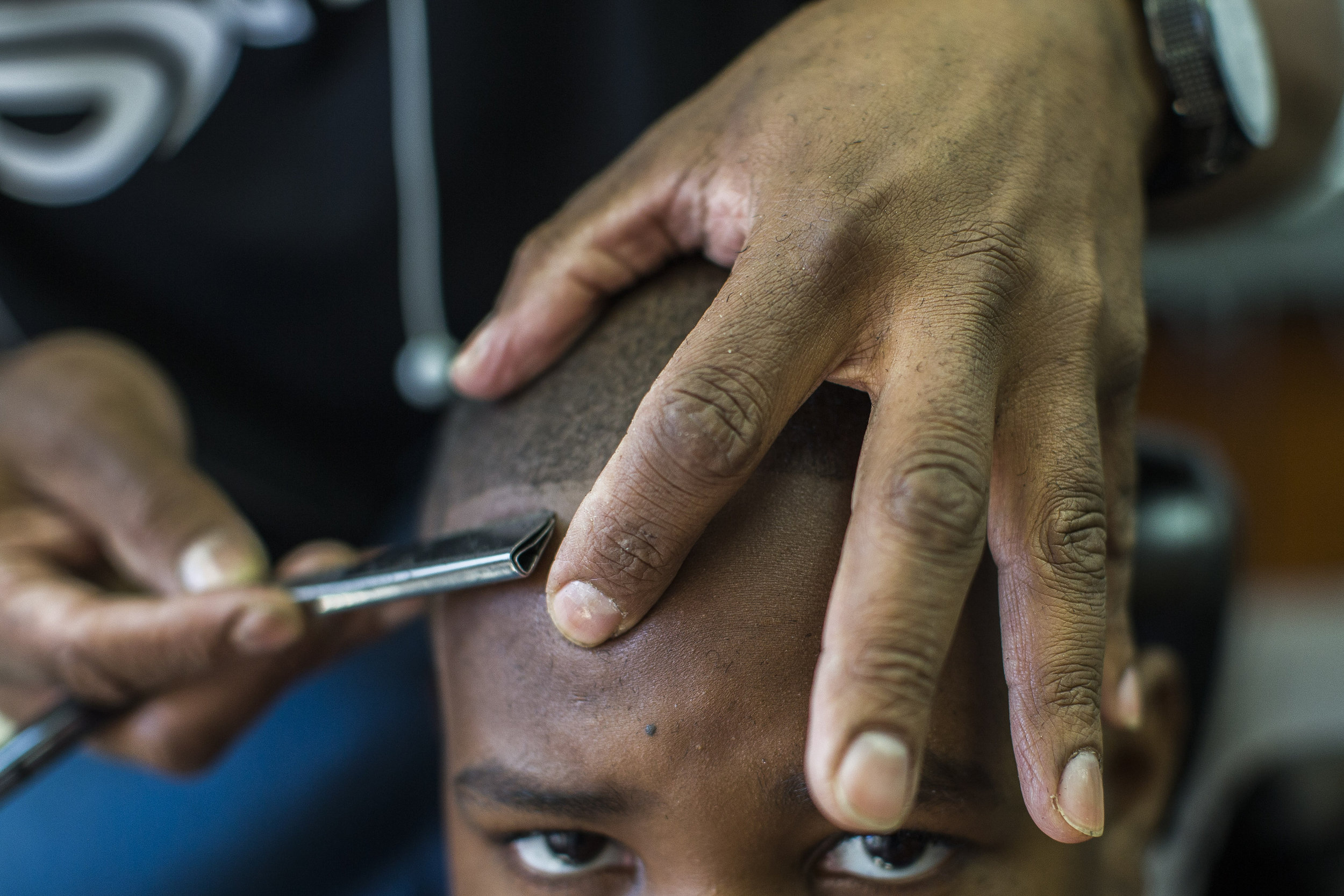 Desmond Younge, 9, has his hair cut during a free back to school haircut event at Mattapan's Finest Barbers in Boston, Massachusetts, September 6, 2015. &nbsp;This is the sixth annual event that the shop has given free haircuts and school supplies t