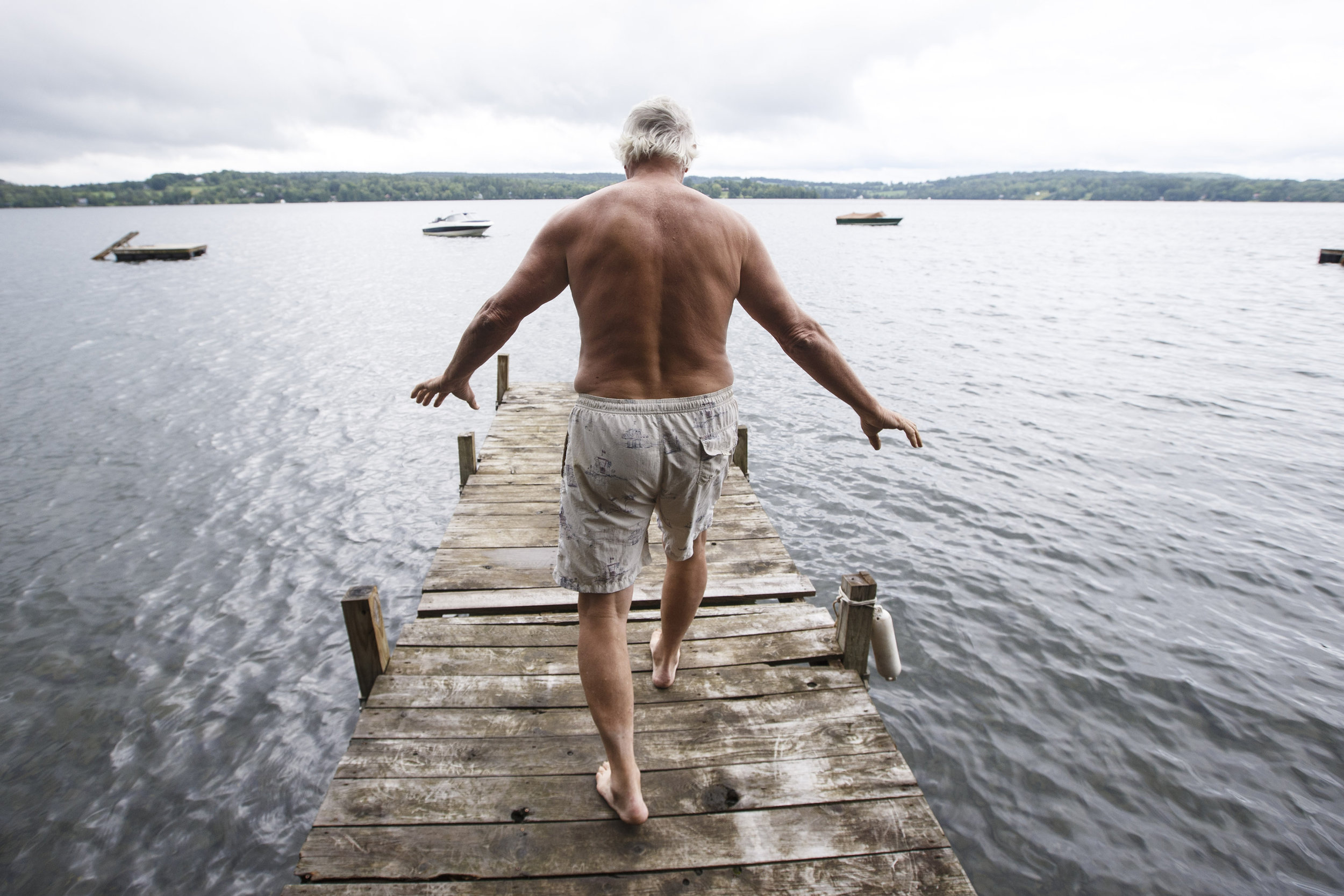  Former Red Sox pitcher and candidate for Vermont Governor Bill "Spaceman" Lee walks out onto a dock to swim in the Caspian Lake in Greensboro, VT, August 17, 2016. The swim helps Lee, who still pitches in a senior league, &nbsp;exercise his aging hi