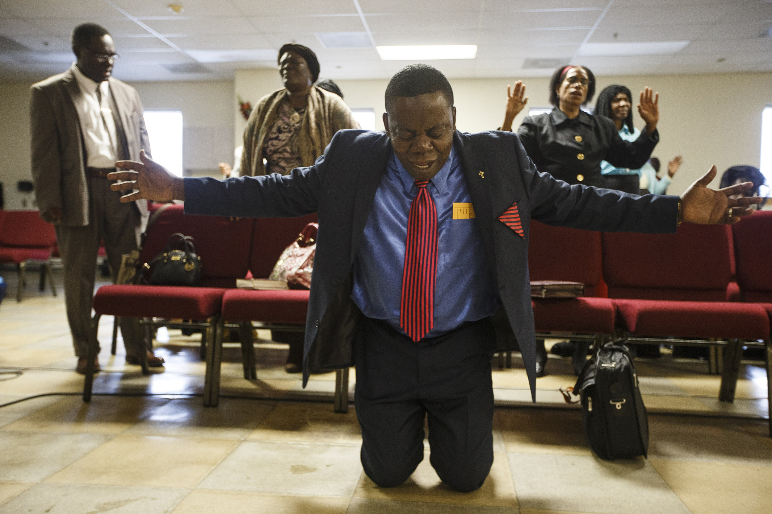  Pastor Jean Jeune leads congregants prays for hurricane victims during service at the First Christian Church Source of Grace, a church frequented by the Haitian community, in Boston, MA, October 9, 2016. &nbsp; &nbsp;Several members of the church ha