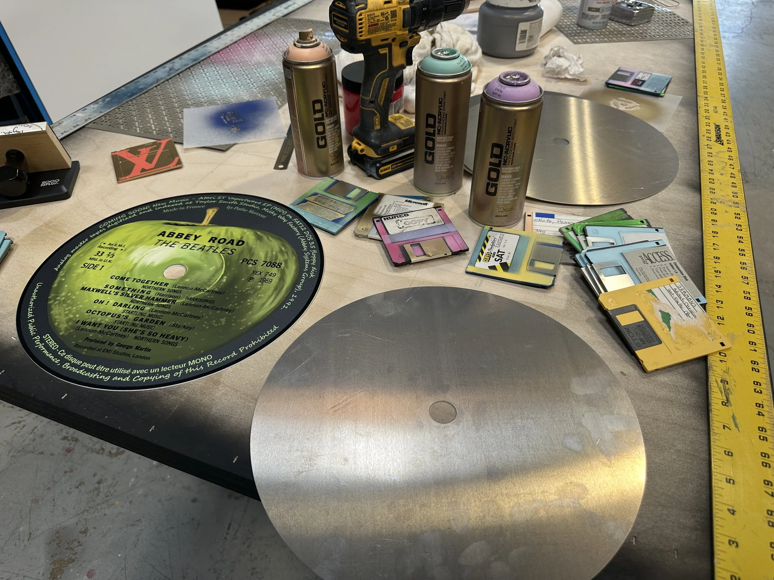  Studio view of aluminum center discs, vintage floppy disks and materials used in Taylor Smith’s Vinyl Series. 