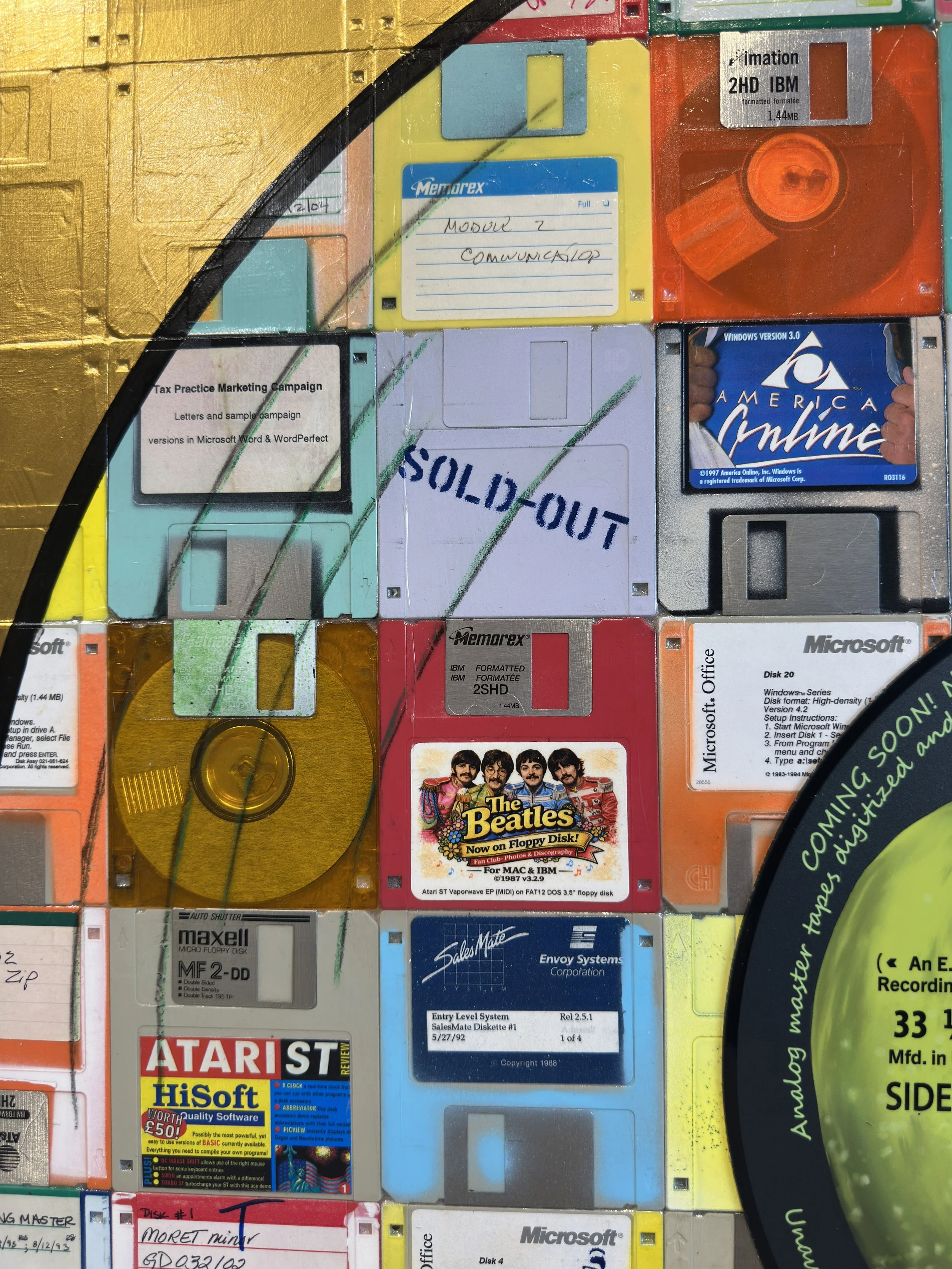  Detail of vintage labeled floppy disks and gold surface in Taylor Smith’s Abbey Road Side 1 artwork. 