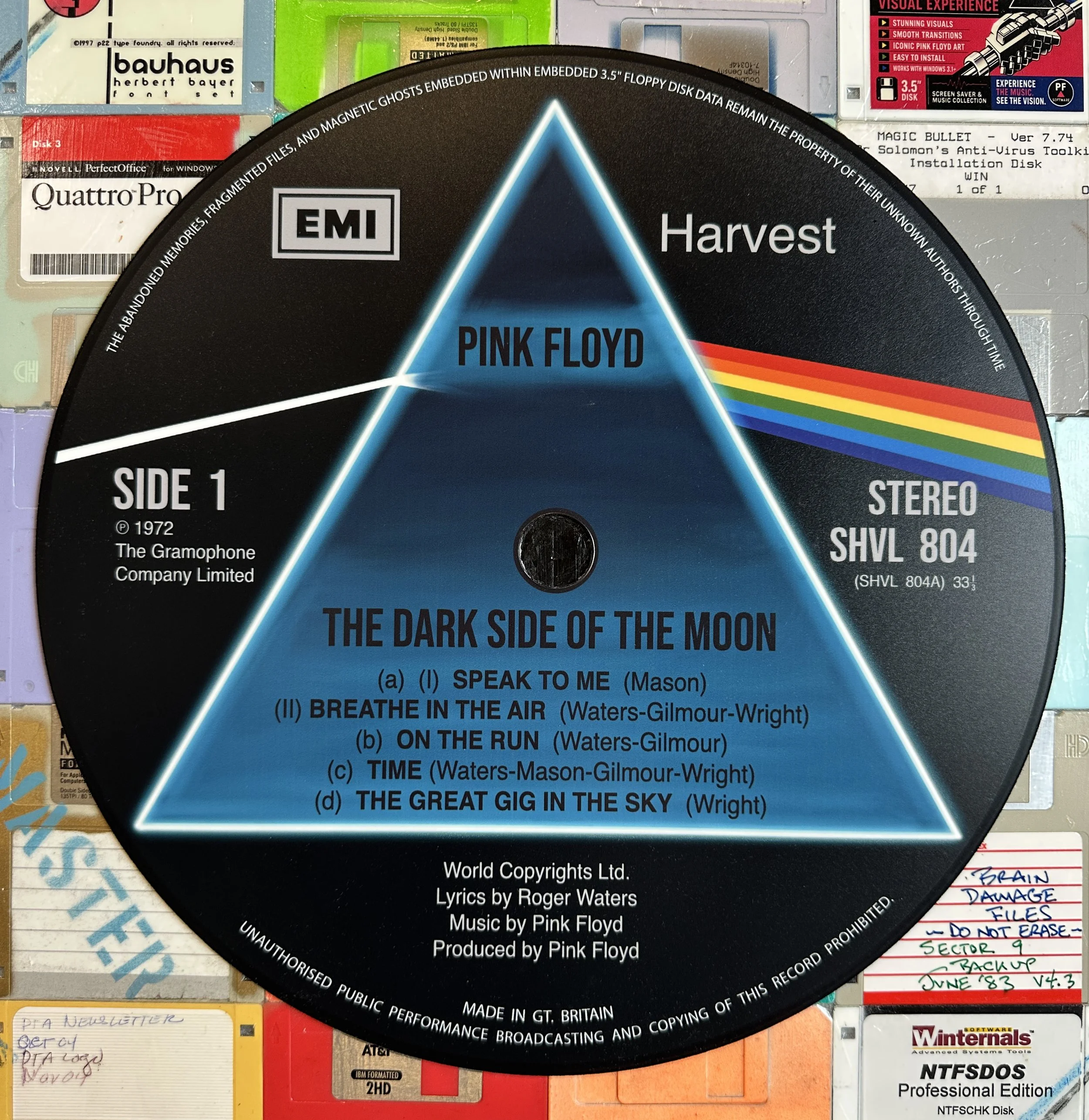 Close-up of Taylor Smith’s reimagined center disc for Pink Floyd’s The Dark Side of the Moon (Side 1), surrounded by vintage floppy disks.