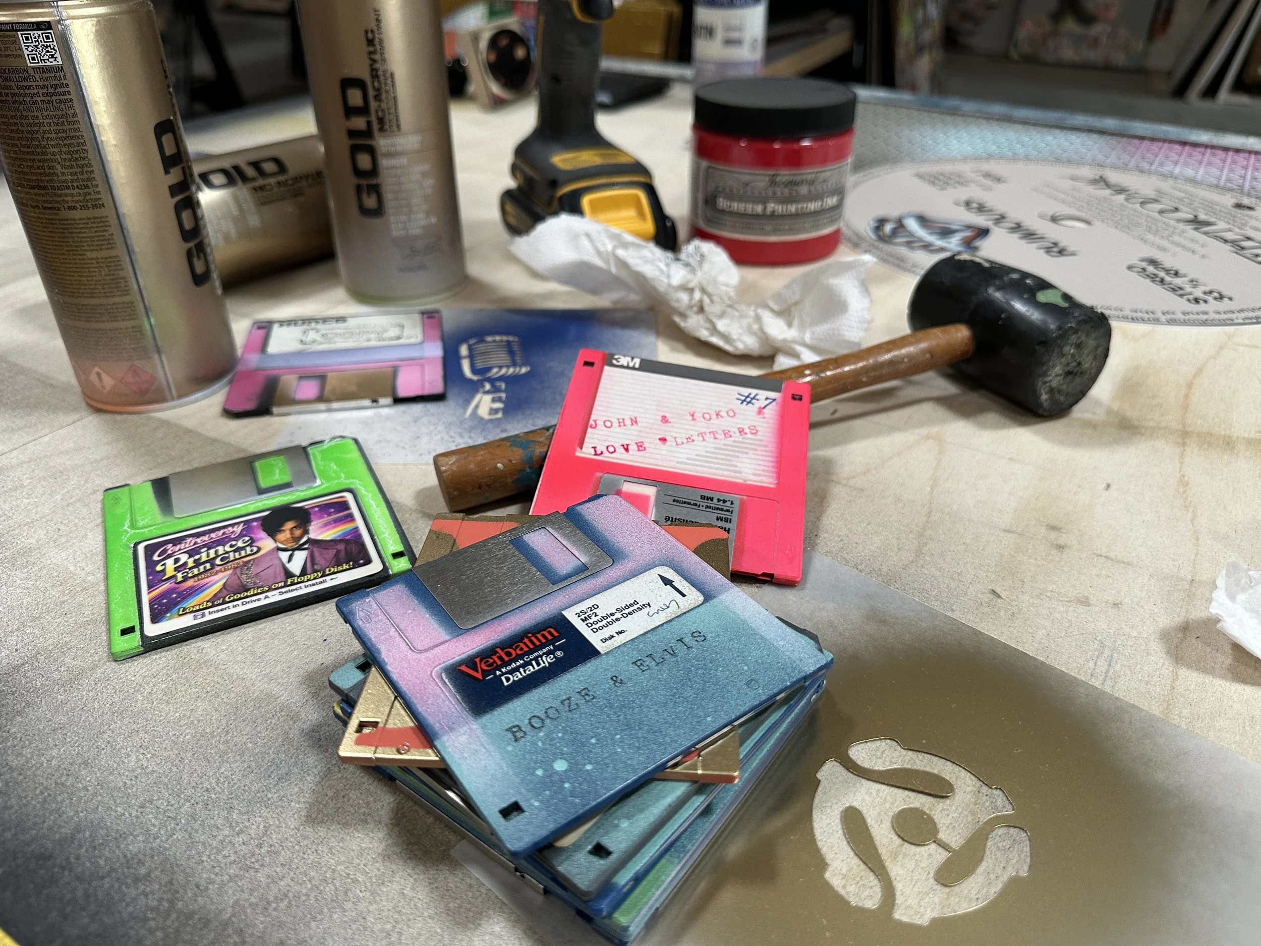 Taylor Smith studio work table with hand painted vintage floppy disks which will be used to create her vinyl series record album paintings