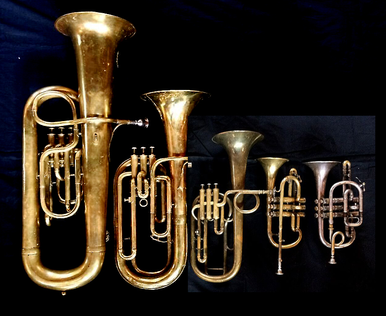 Left to Right: Contrabass saxhorn in E-flat by E. Daniel (7167, Marseille, c. 1850), Baritone saxhorn in B-flat by Couesnon (44139, 94 Rue D’angouleme Exposition Universelle De Paris, 1900), Tenor saxhorn in F/E flat/D by Antoine Courtois (Paris, c. 1855), sold by Arthur Chappell (London), Cornet in E-flat by Couesnon (94 Rue D’angouleme Exposition Universelle De Paris 1900), Cornet in C/B-flat by Henry Distin New American Model (9580, Williamsport, PA, c. 1895) ,.