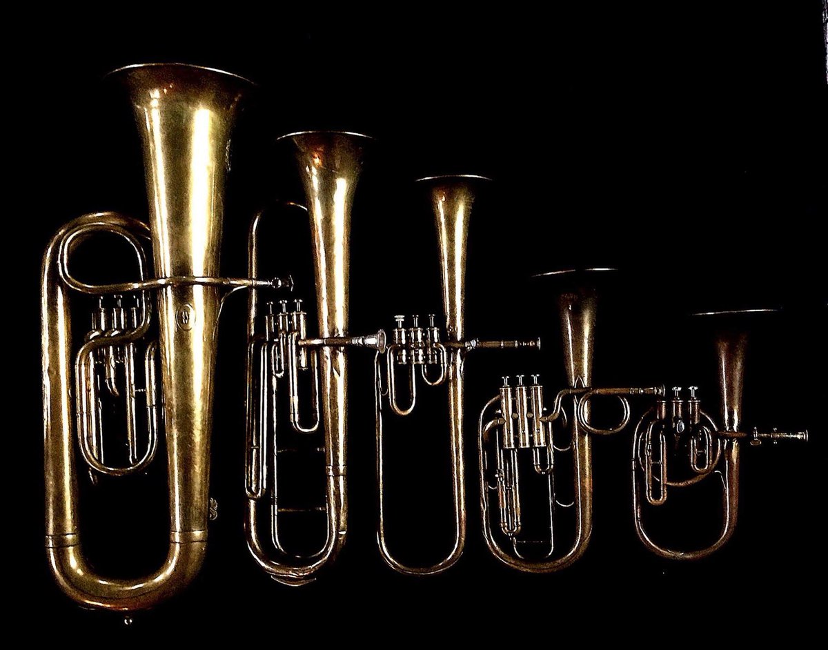 Left to Right: Contrabass saxhorn in E-flat by E. Daniel (7167, Marseille, c. 1850) . Baritone saxhorn in C/B flat by Couturier (Lyon, c. 1865), Contralto saxhorn in B-flat by Adolphe Sax (Paris, c. 1849 1850), sold by Distin & Sons, Cranbourne St. Leicester Square, London, Tenor saxhorn in F/E flat/D by Antoine Courtois (Paris, c. 1855), sold by Arthur Chappell (London) Contralto saxhorn in B-flat by J. Grass (32 Rue des Ponts de Comines, Lille, est. 1868).