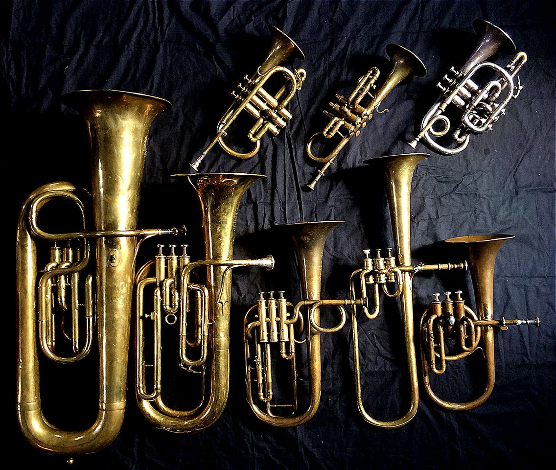 Top row left to right: Cornet in E-flat by Couesnon (94 Rue D’angouleme Exposition Universelle De Paris 1900), Cornet in E-flat by Henry Distin (Gt. Newport Street, London, c. 1851-1868), Cornet in C/B-flat by Henry Distin New American Model (9580, Williamsport, PA, c. 1895) , Bottom row left to right: Contrabass saxhorn in E-flat by E. Daniel (7167, Marseille, c. 1850), Baritone saxhorn in B-flat by Couesnon (44139, 94 Rue D’angouleme Exposition Universelle De Paris, 1900) , Tenor saxhorn in F/E flat/D by Antoine Courtois (Paris, c. 1855), sold by Arthur Chappell (London), Contralto saxhorn in B flat by Adolphe Sax (Paris, c. 1849 - 1850), sold by Distin & Sons, Cranbourne St. Leicester Square, London, Contralto saxhorn in B-flat by J. Grass (32 Rue des Ponts de Comines, Lille, est. 1868.