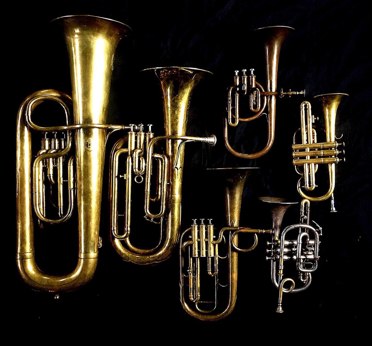 Left to Right: Contrabass saxhorn in E-flat by E. Daniel (7167, Marseille, c. 1850), Baritone saxhorn in B-flat by Couesnon (44139, 94 Rue D’angouleme Exposition Universelle De Paris, 1900) , Tenor saxhorn in F/E flat/D by Antoine Courtois (Paris, c. 1855), sold by Arthur Chappell (London), Contralto saxhorn in B-flat by J. Grass (32 Rue des Ponts de Comines, Lille, est. 1868., Cornet in C/B-flat by Henry Distin New American Model (9580, Williamsport, PA, c. 1895) , Cornet in B-flat/A by F. Besson (44292, 96 Rue D’angouleme, Paris c. 1892).