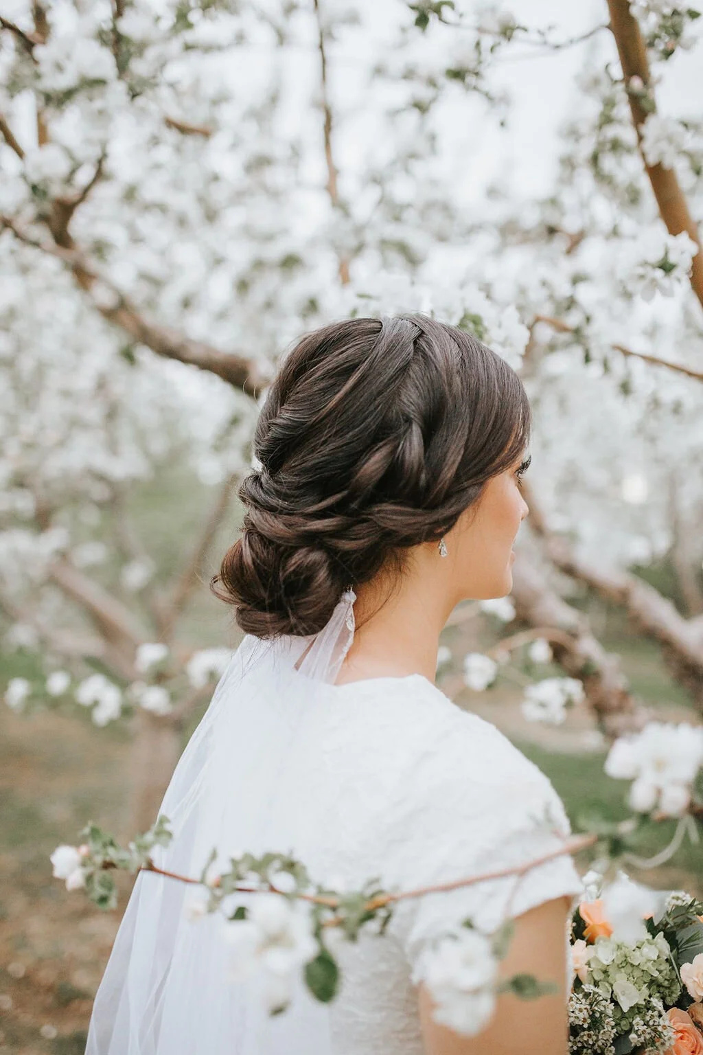bridal-hairstyle-updo-wedding-trends-2020-effortless-braided-updo-look-for-the-light-photo-video