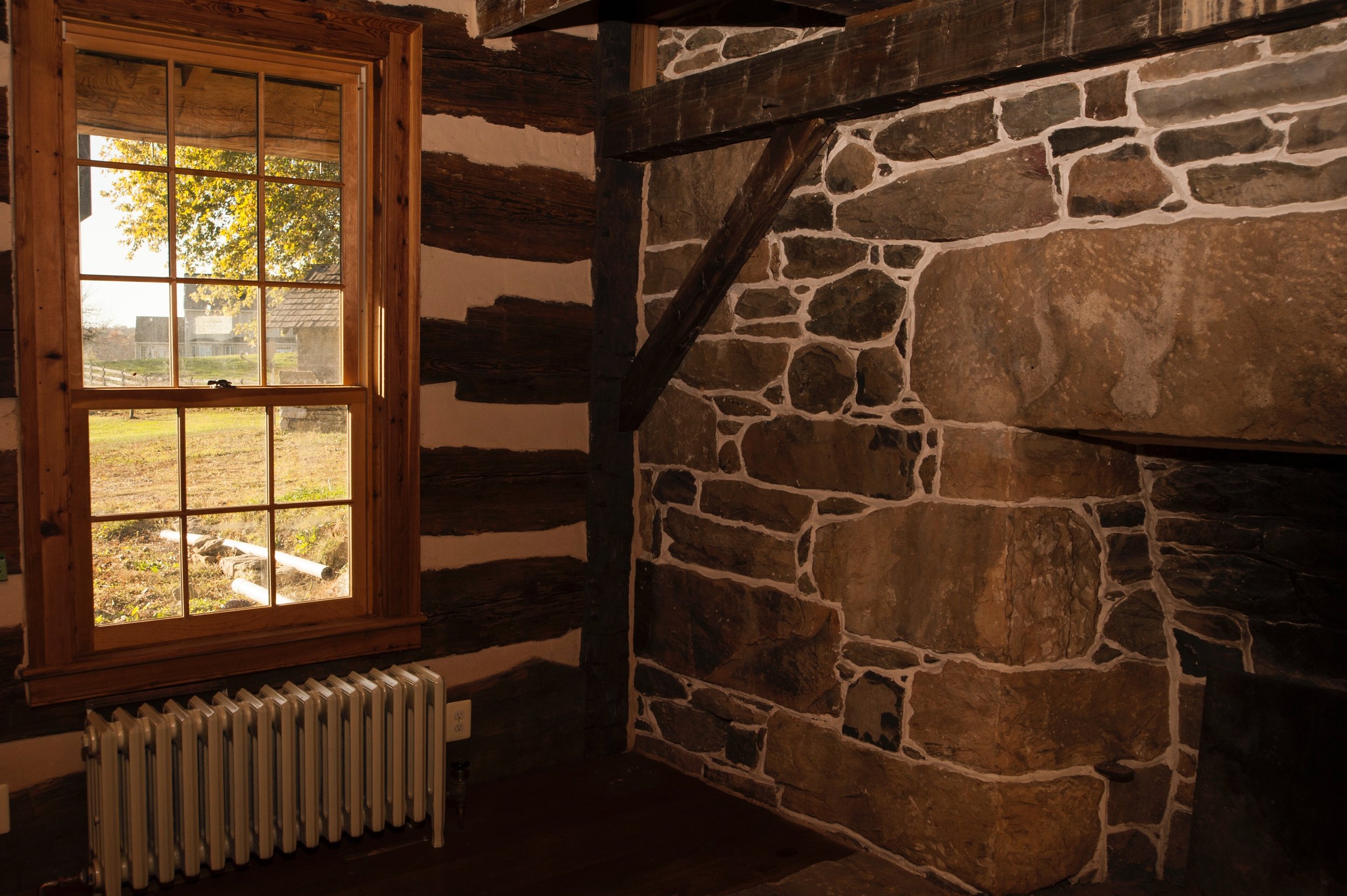  In the log house addition, new windows are set into reclaimed wood frames. 