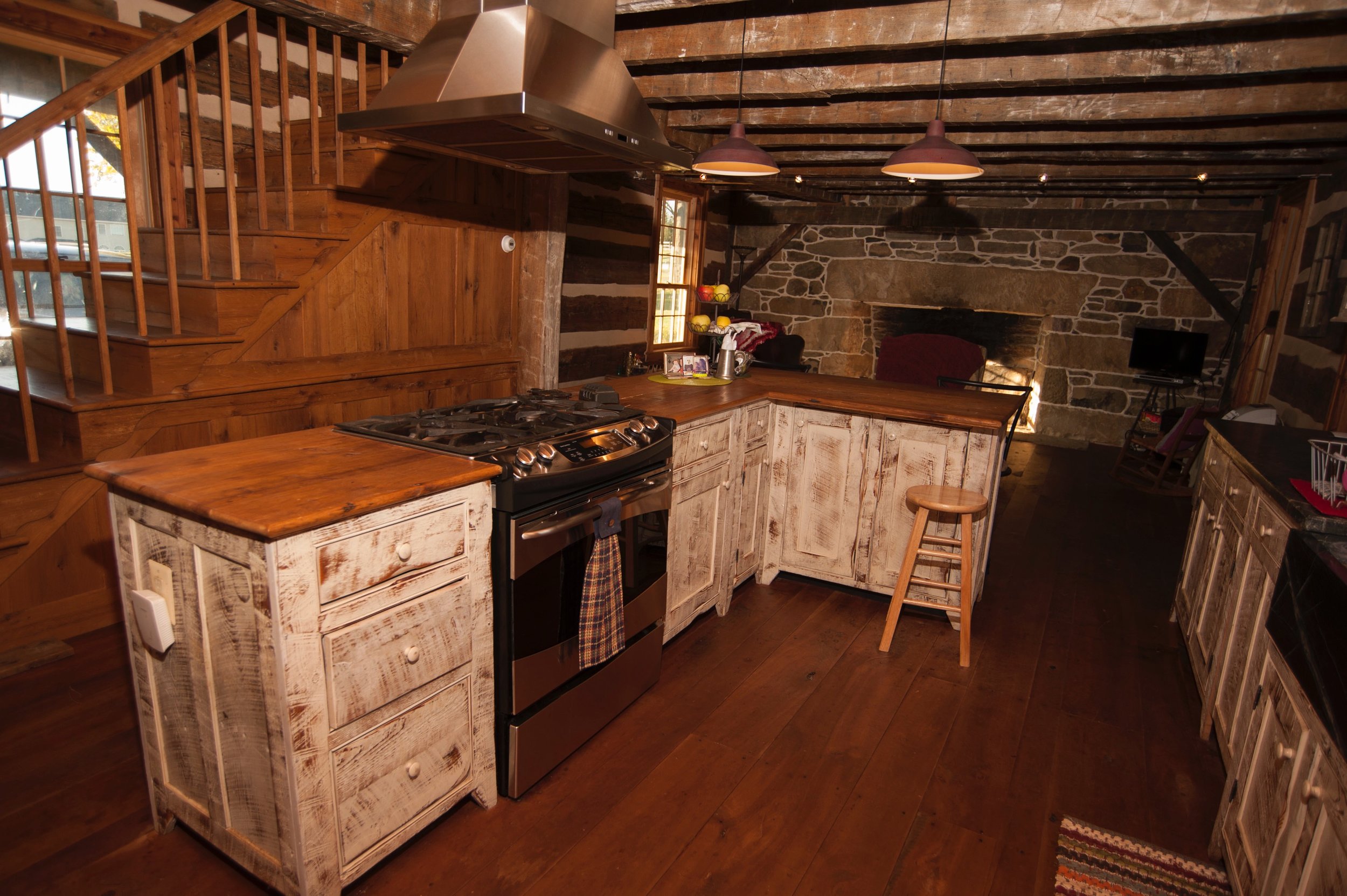  The log house kitchen features cabinetry designed and built by Allen Cochran. 