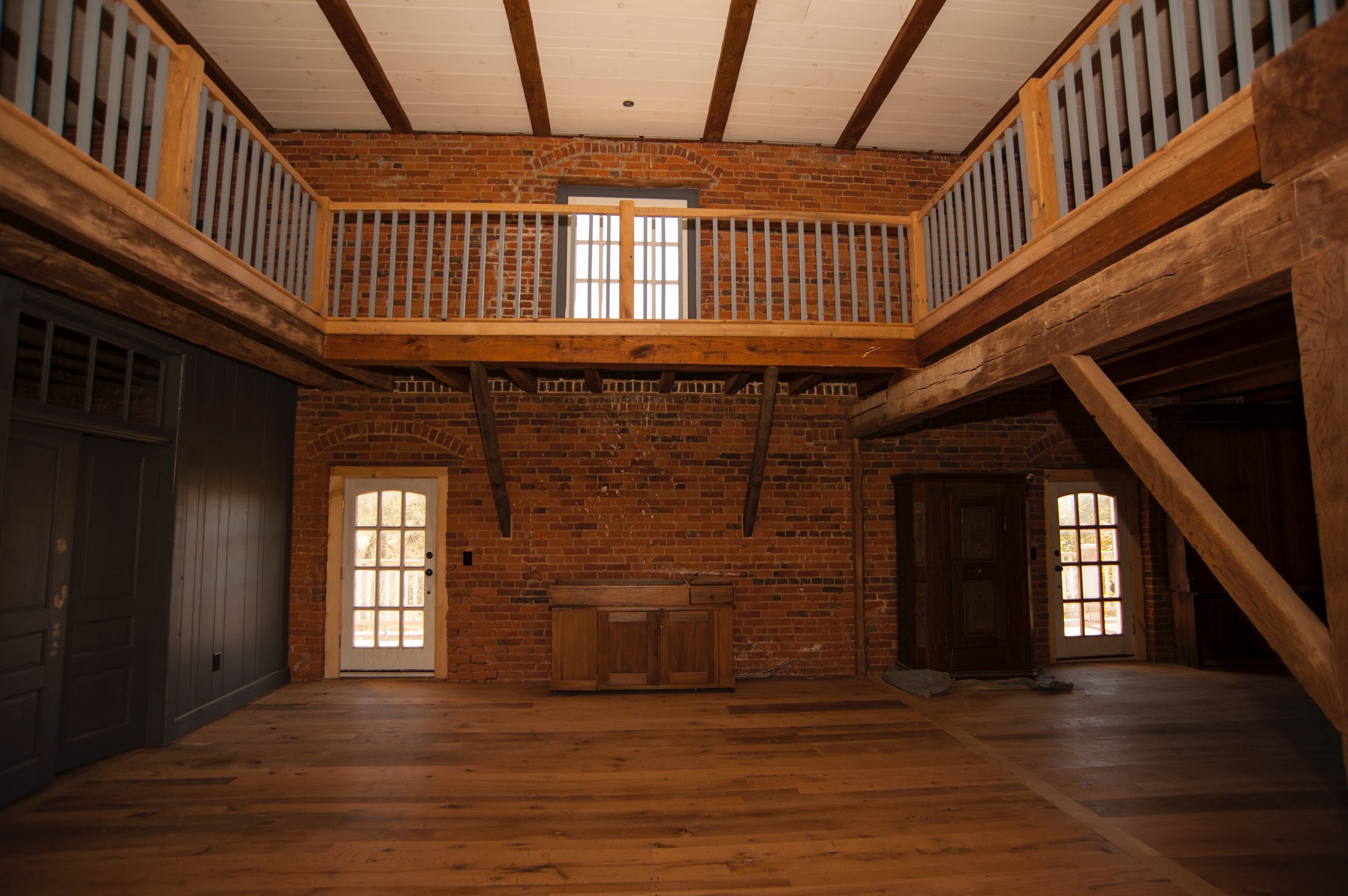  Railings on the upper level create a safewalkway between the sleeping area on one side and an entertainment center on the other. 