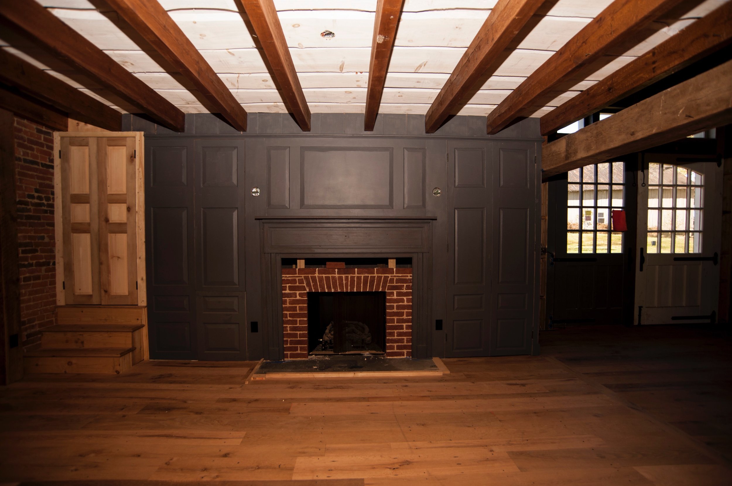  To the left of the main barn entrance is the beamed sitting area with a fireplace.   