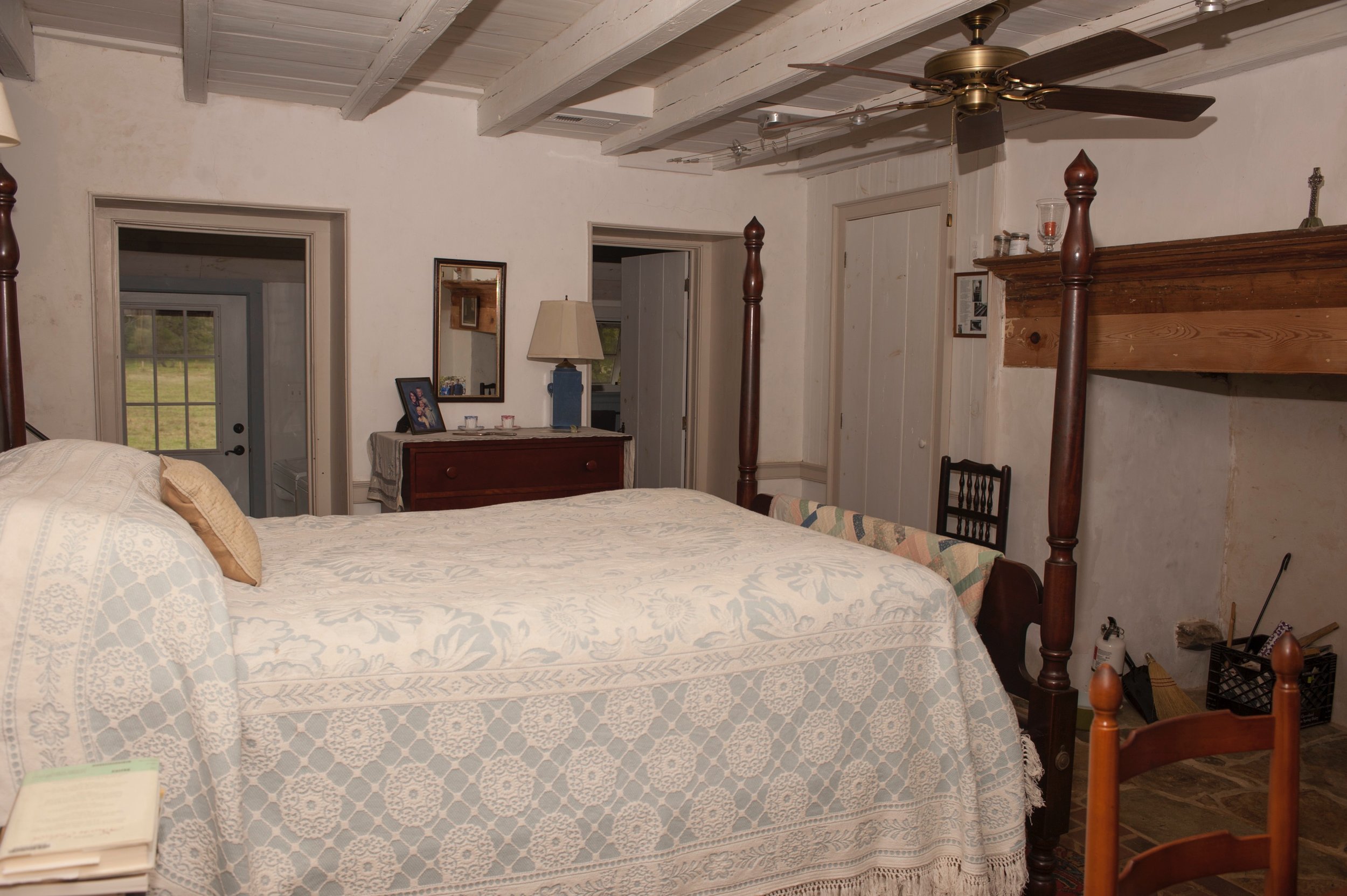  Master bedroom features restored beams and radiant-heat brick floor. 